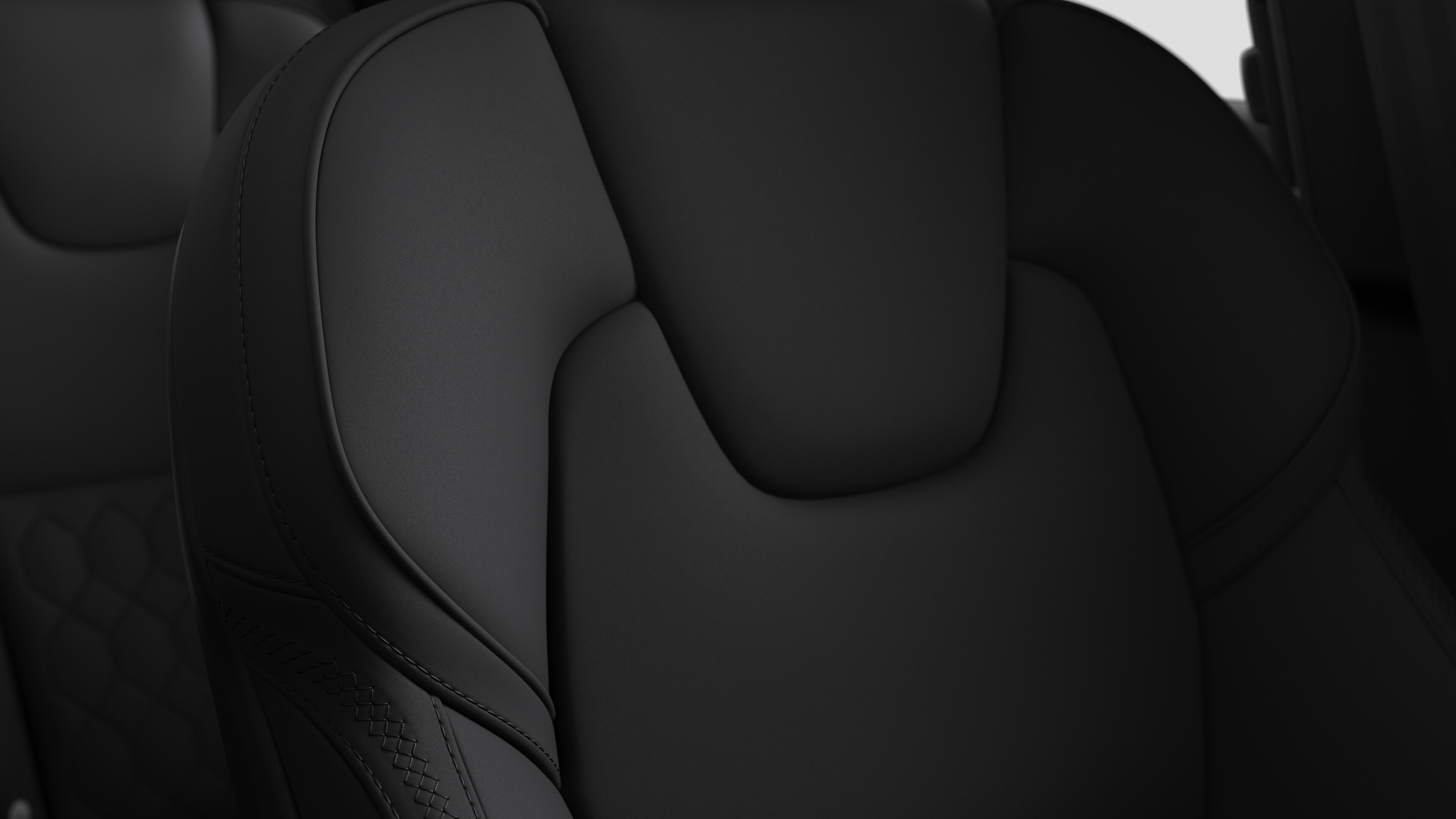 Close-up of Volvo car interior seat detail showing stitching and a small Swedish flag tag.
