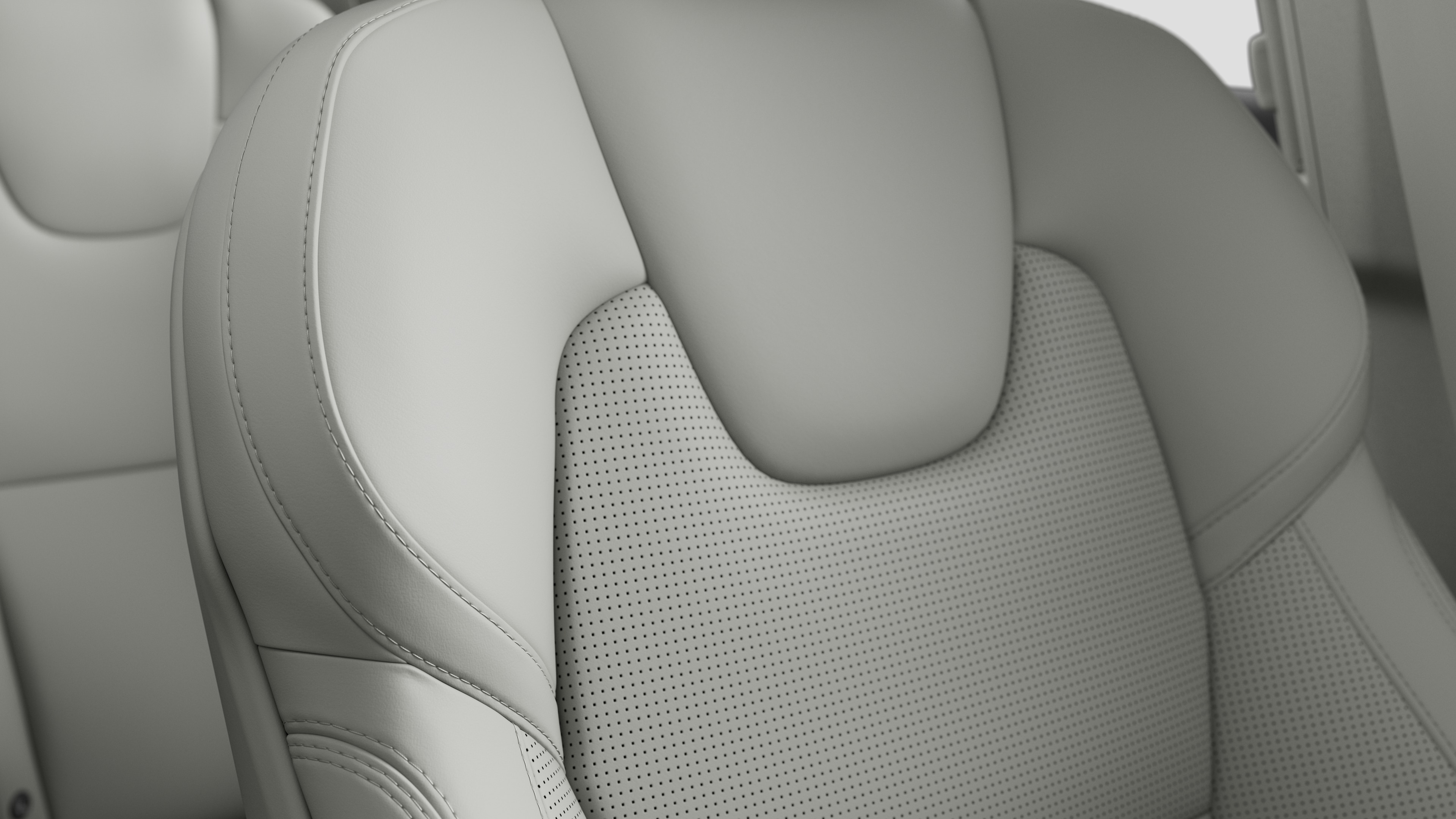Close-up of Volvo car interior seat detail showing stitching and a small Swedish flag tag.