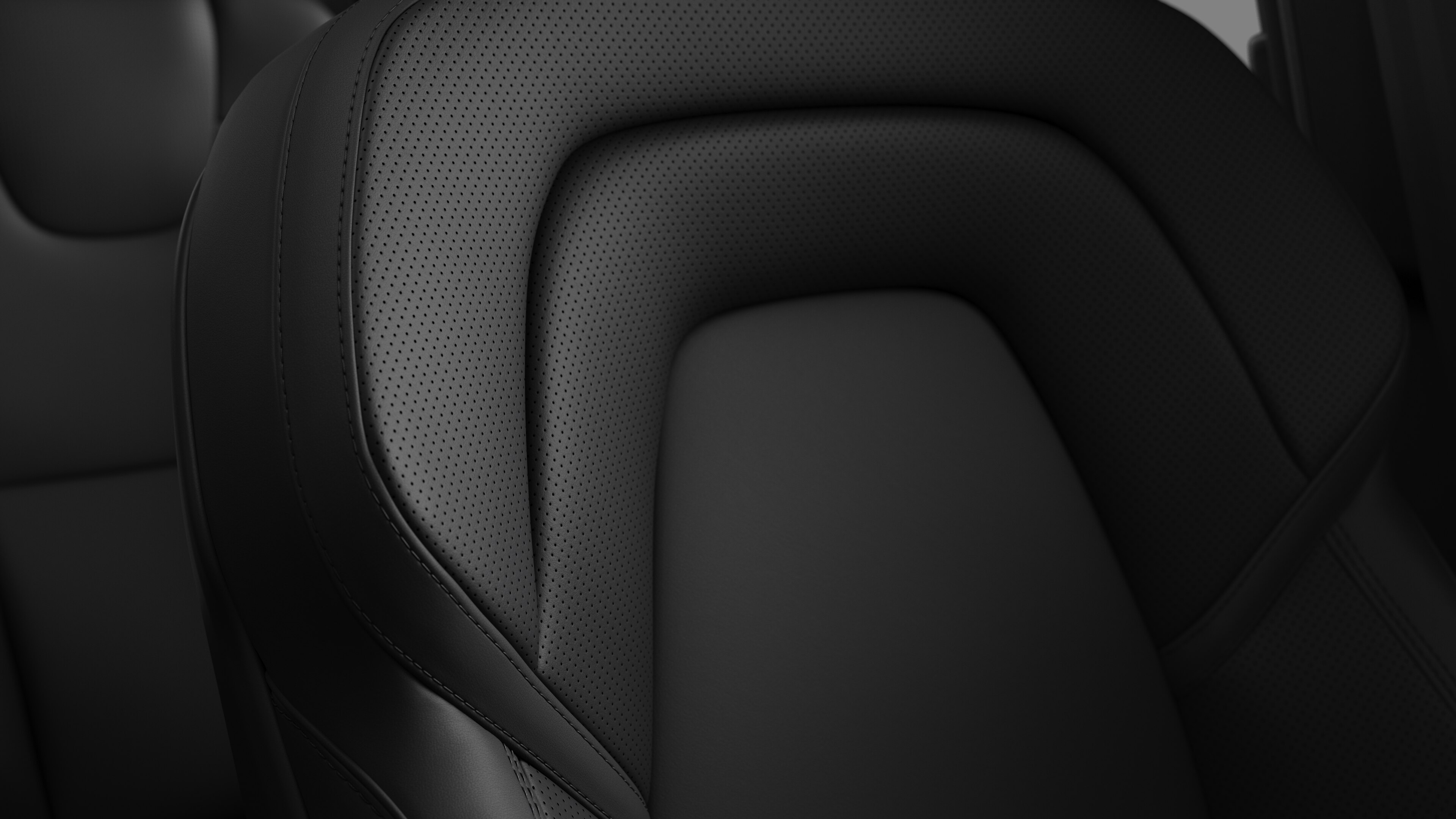 Close-up of Volvo car interior seat detail showing stitching and a small Swedish flag tag.