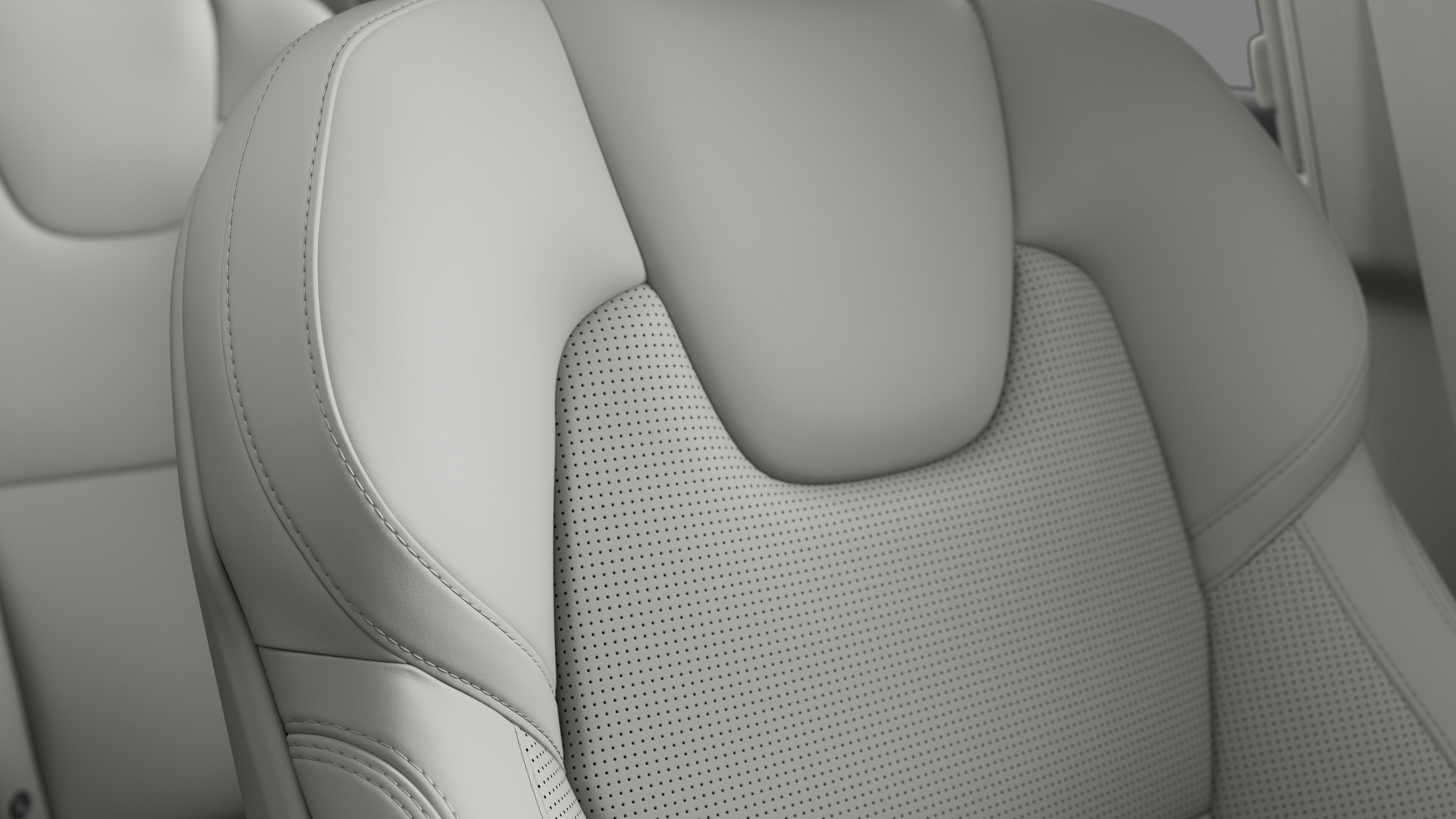 Close-up of Volvo car interior seat detail showing stitching and a small Swedish flag tag.