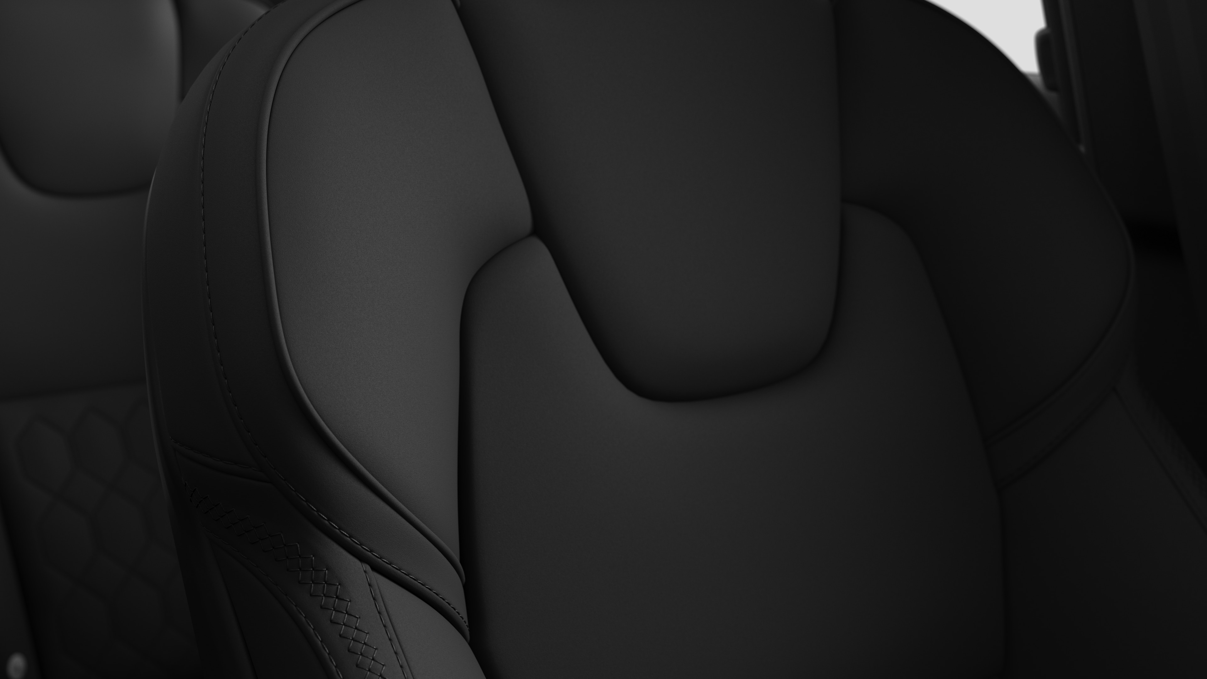 Close-up of Volvo car interior seat detail showing stitching and a small Swedish flag tag.