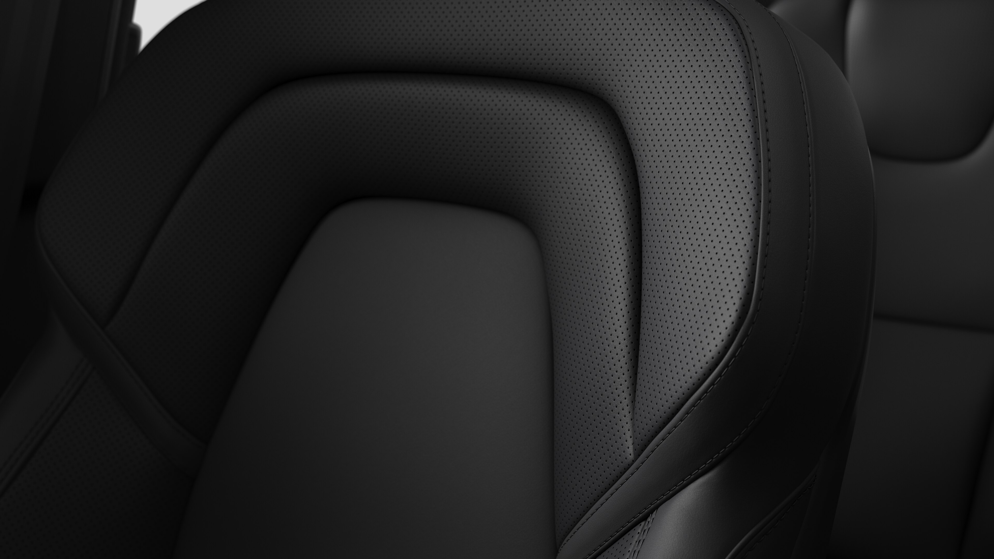 Detailný záber na detail interiéru sedadla vozidla Volvo s prešívaním a malým štítkom so švédskou vlajkou.