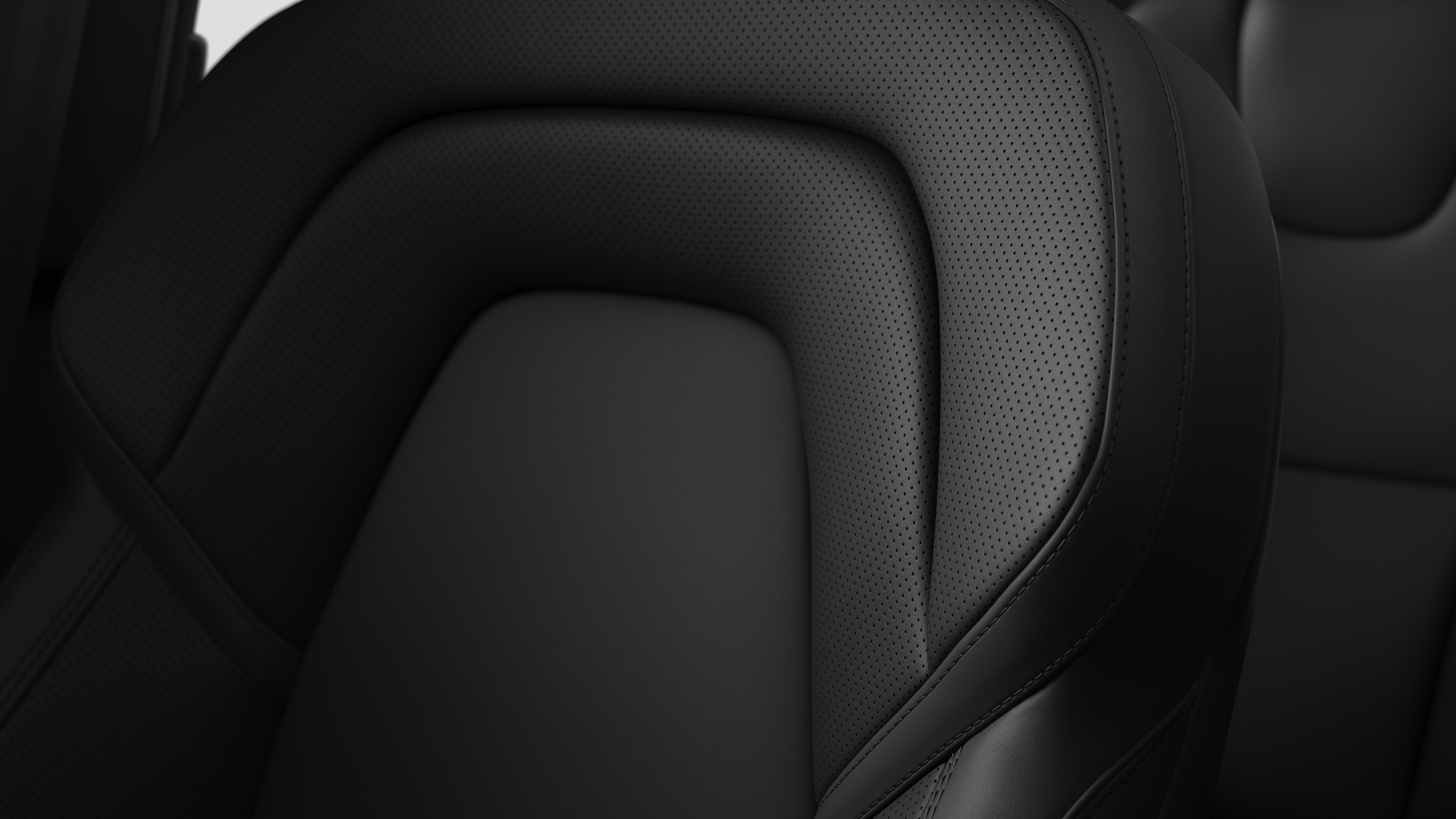 Detalle del asiento interior de un coche Volvo en el que se ven costuras y una pequeña etiqueta con la bandera sueca.