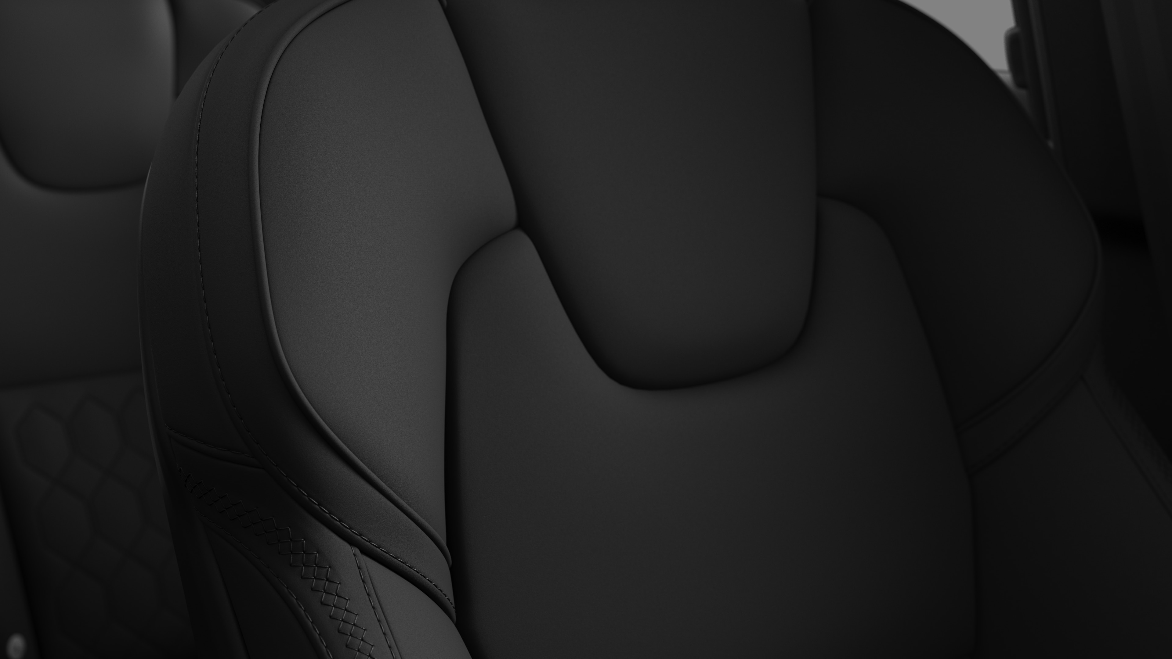Close-up of Volvo car interior seat detail showing stitching and a small Swedish flag tag.