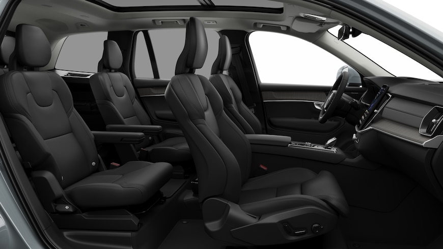 Volvo car interior side view showcasing front seats, rear passenger seats, steering wheel, dashboard, and center console, set against plain studio background.