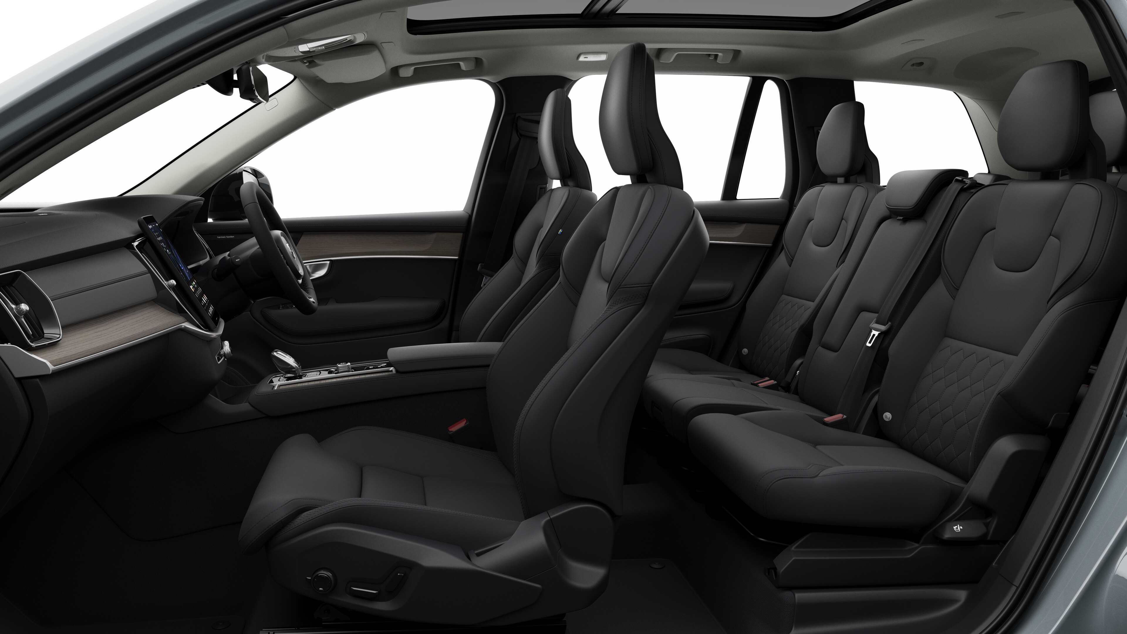 Volvo car interior side view showcasing front seats, rear passenger seats, steering wheel, dashboard, and center console, set against plain studio background.