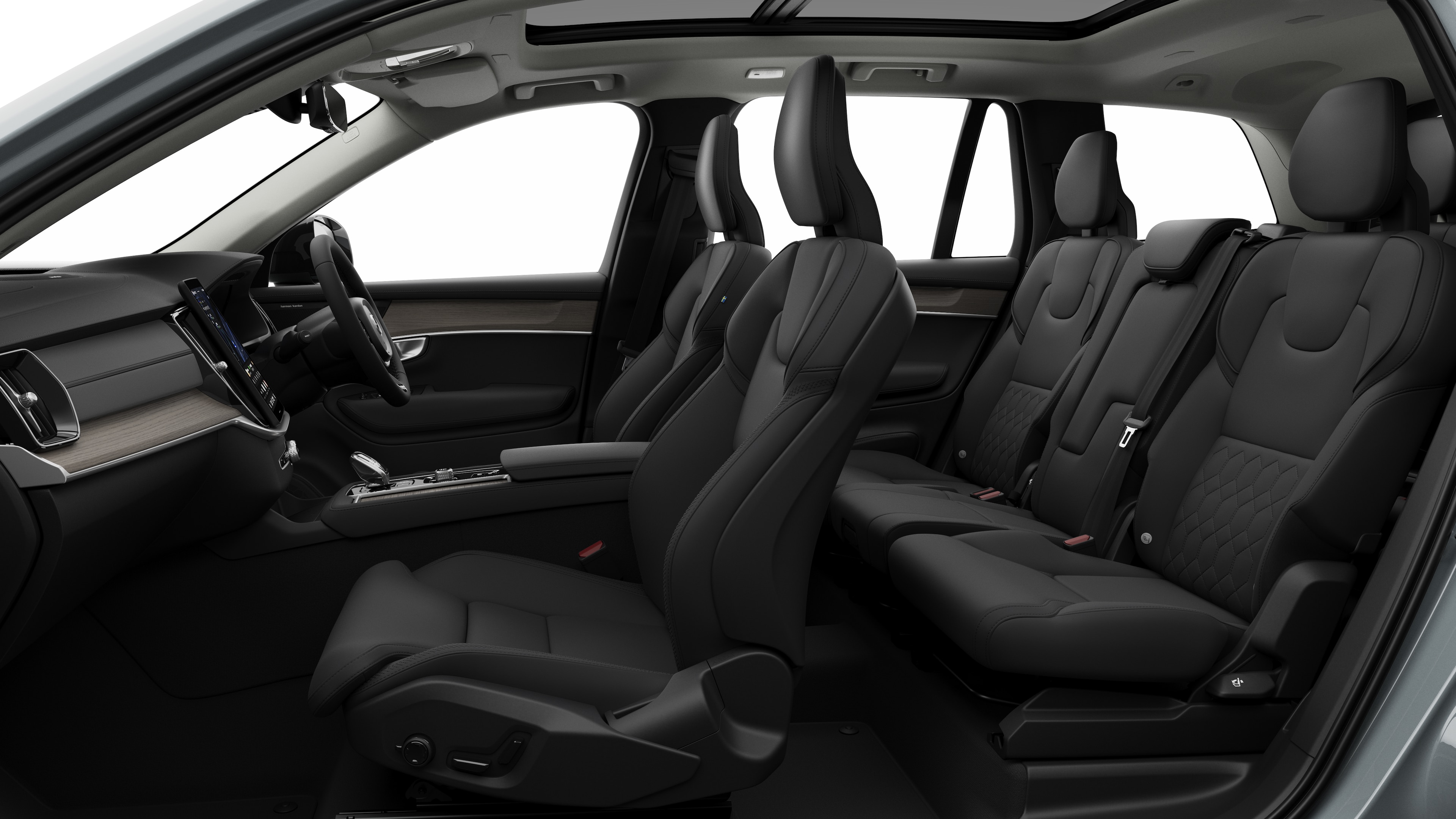 Volvo car interior side view showcasing front seats, rear passenger seats, steering wheel, dashboard, and center console, set against plain studio background.