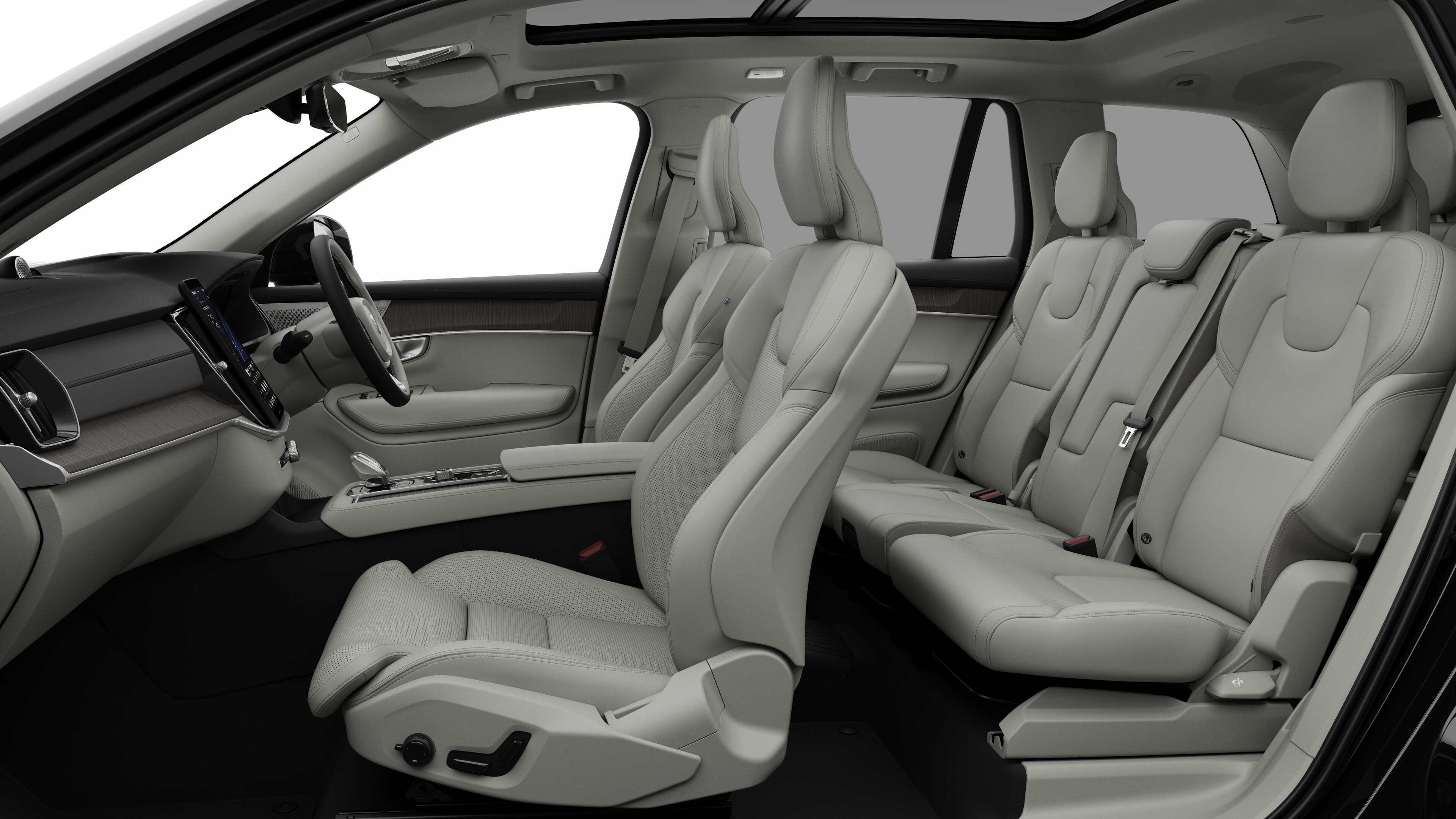 Volvo car interior side view showcasing front seats, rear passenger seats, steering wheel, dashboard, and center console, set against plain studio background.