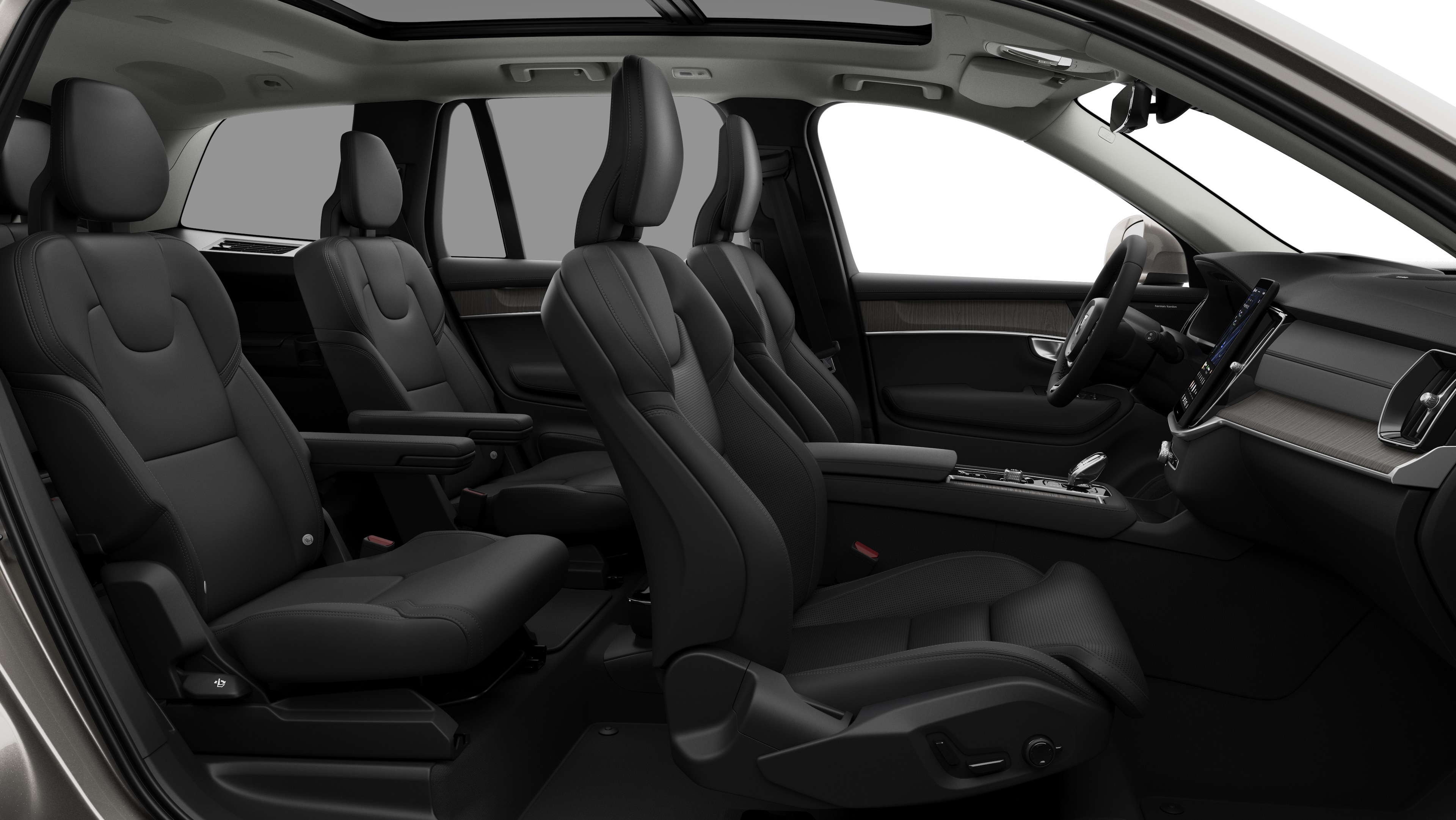 Volvo car interior side view showcasing front seats, rear passenger seats, steering wheel, dashboard, and center console, set against plain studio background.