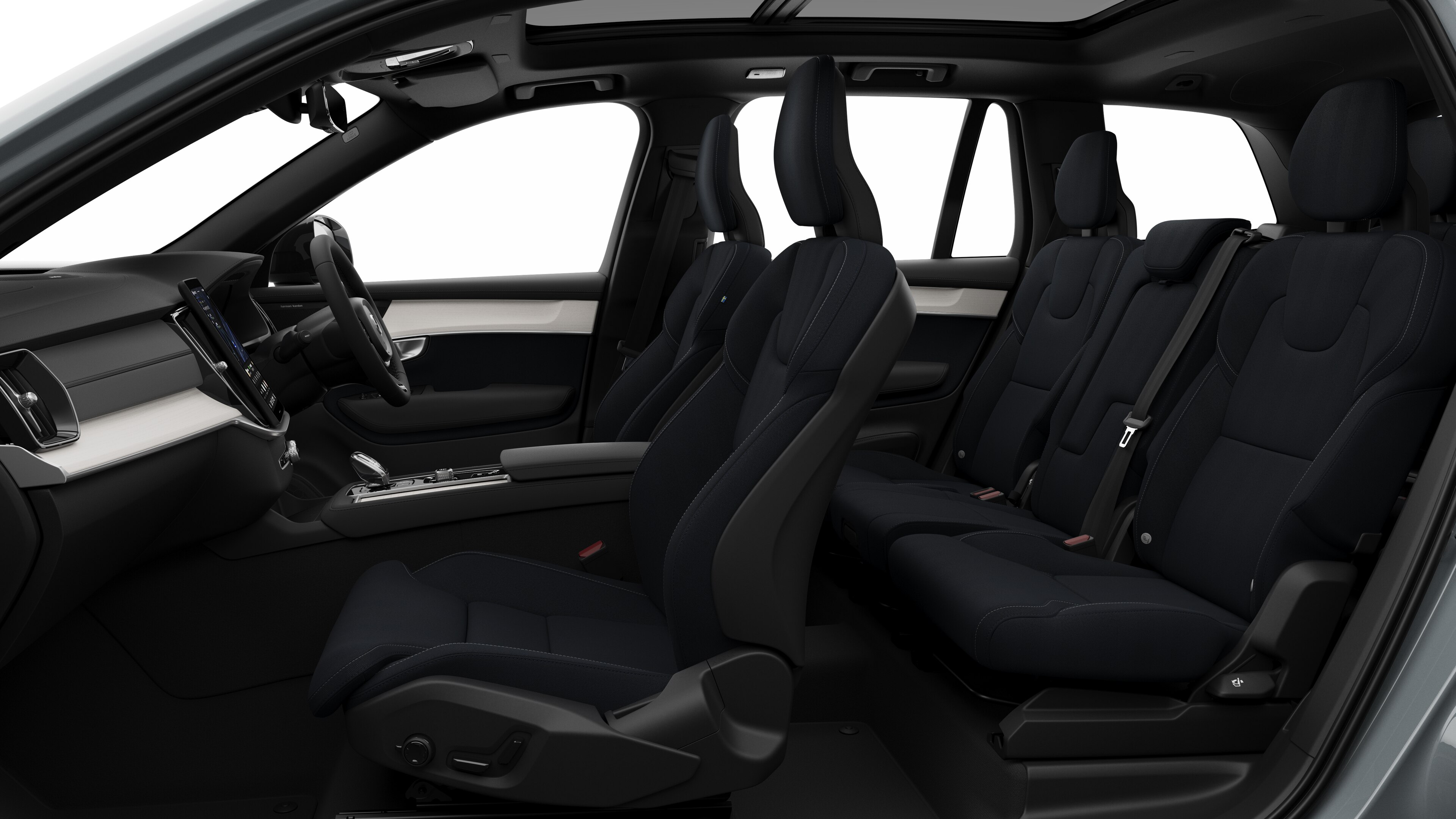 Volvo car interior side view showcasing front seats, rear passenger seats, steering wheel, dashboard, and center console, set against plain studio background.