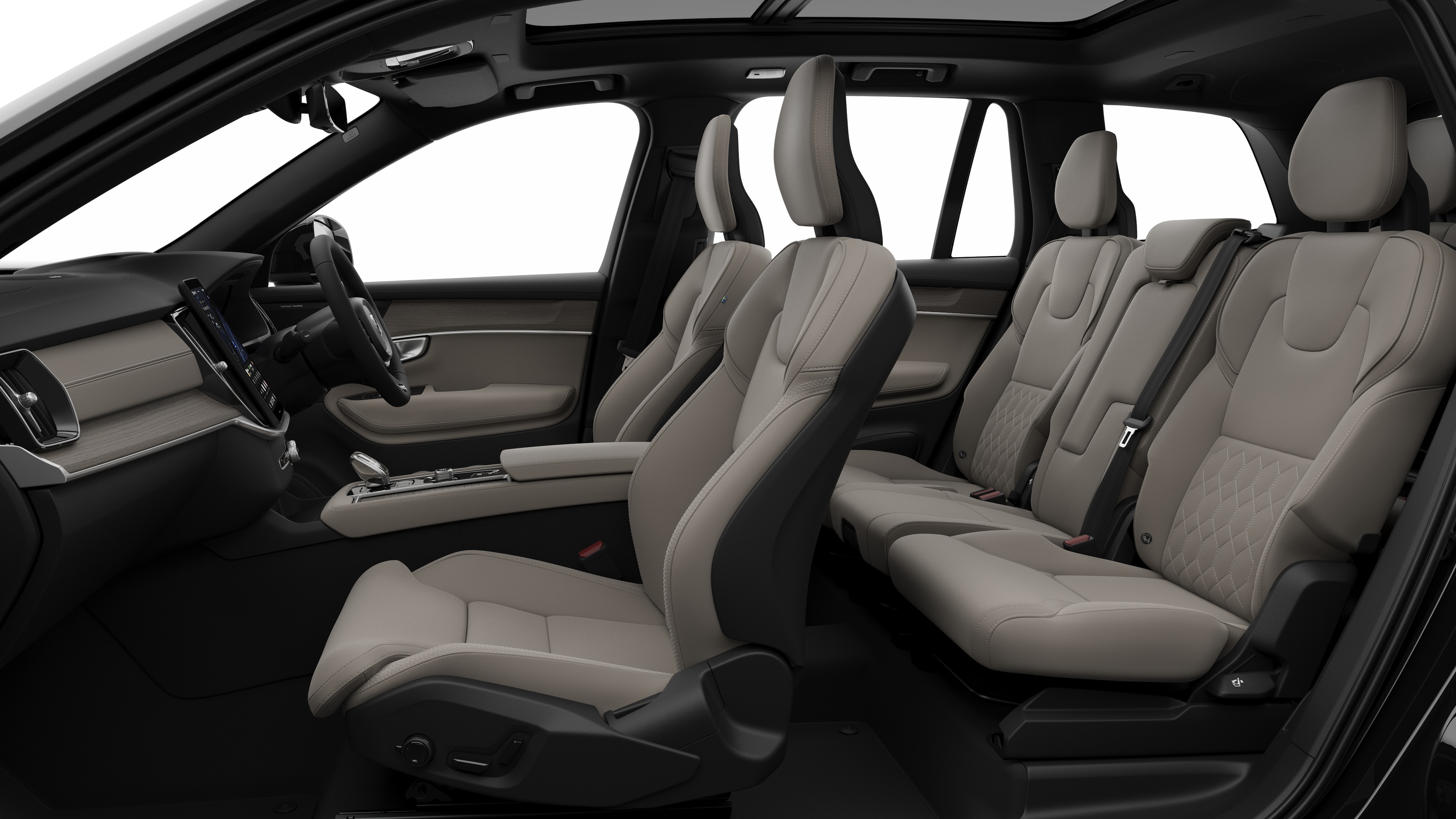 Volvo car interior side view showcasing front seats, rear passenger seats, steering wheel, dashboard, and center console, set against plain studio background.