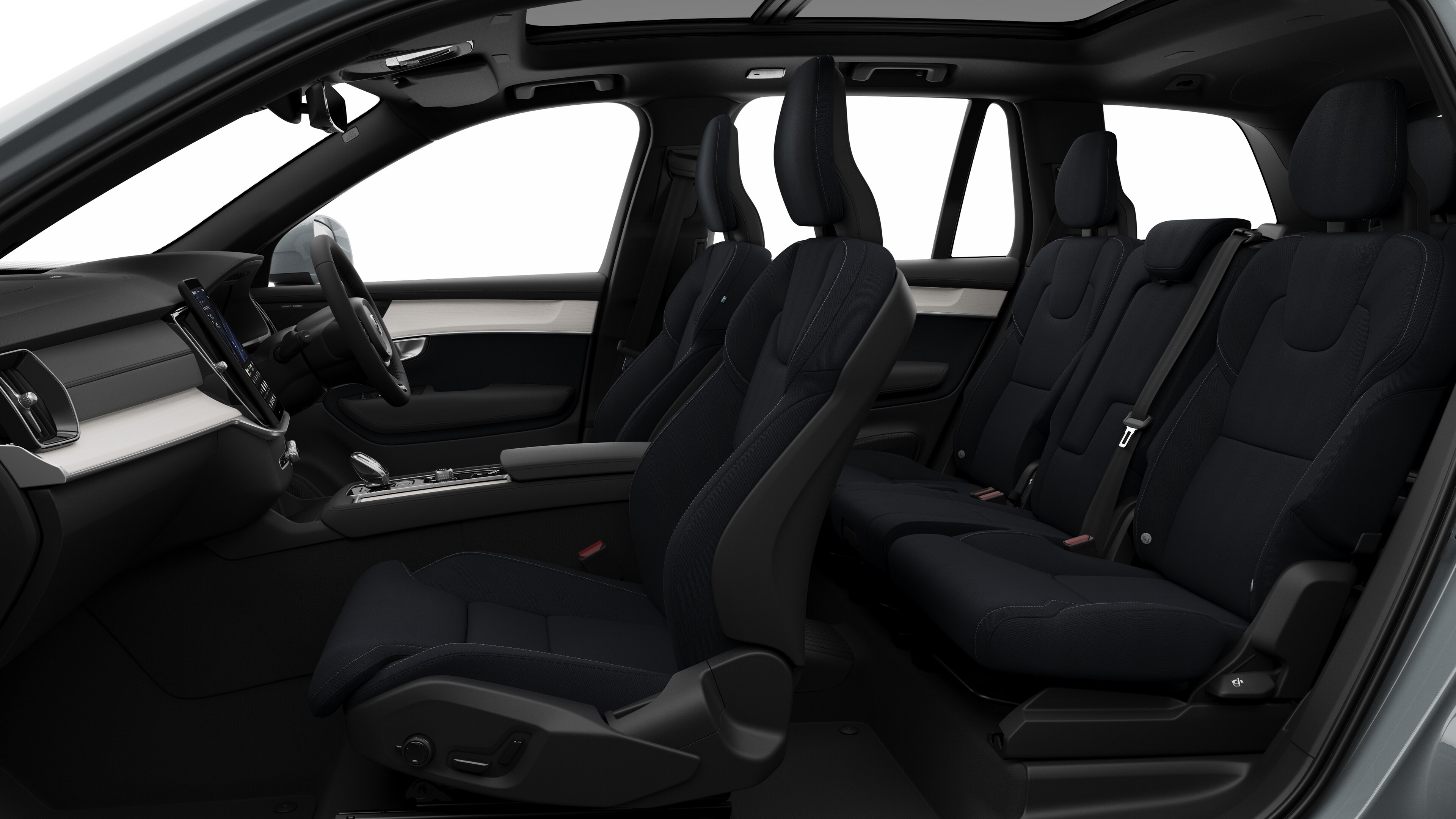 Volvo car interior side view showcasing front seats, rear passenger seats, steering wheel, dashboard, and center console, set against plain studio background.