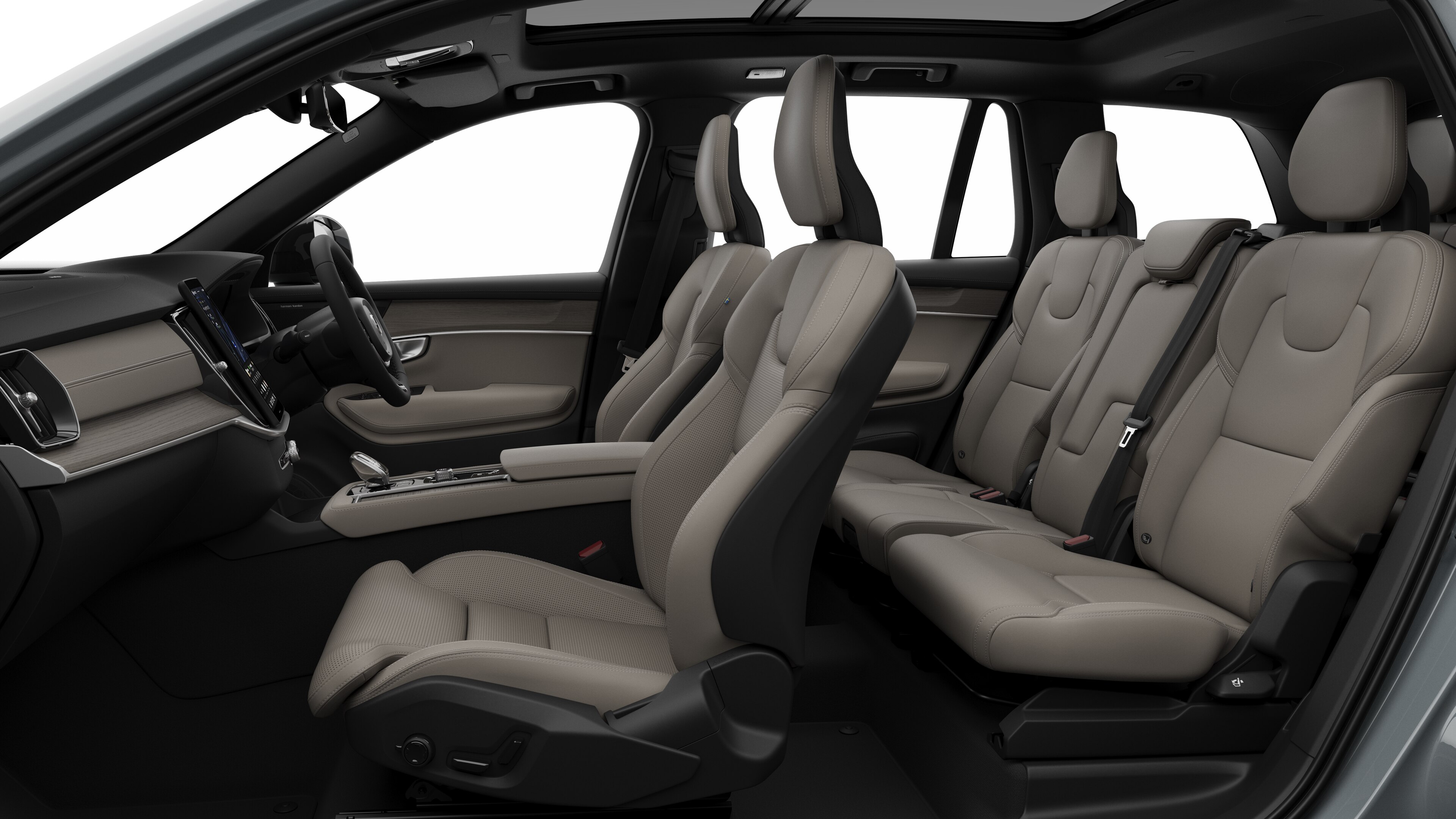 Volvo car interior side view showcasing front seats, rear passenger seats, steering wheel, dashboard, and center console, set against plain studio background.