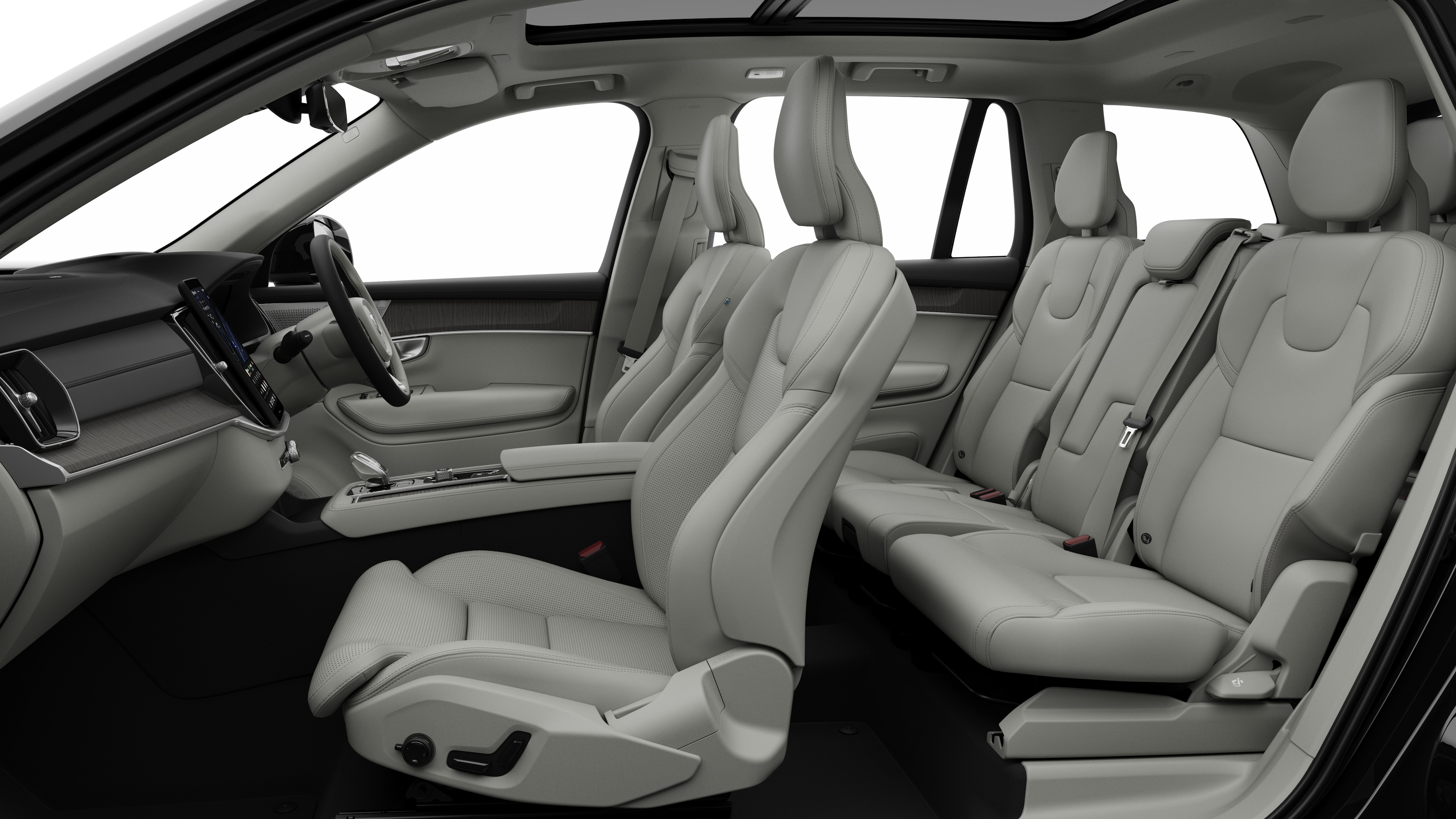 Volvo car interior side view showcasing front seats, rear passenger seats, steering wheel, dashboard, and center console, set against plain studio background.