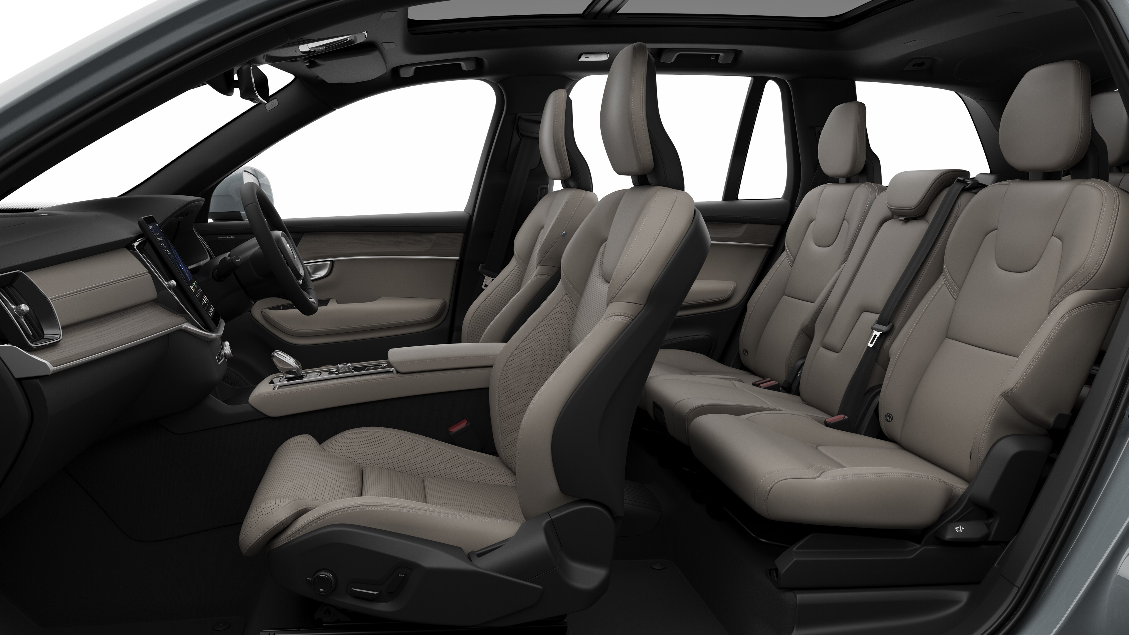 Volvo car interior side view showcasing front seats, rear passenger seats, steering wheel, dashboard, and center console, set against plain studio background.