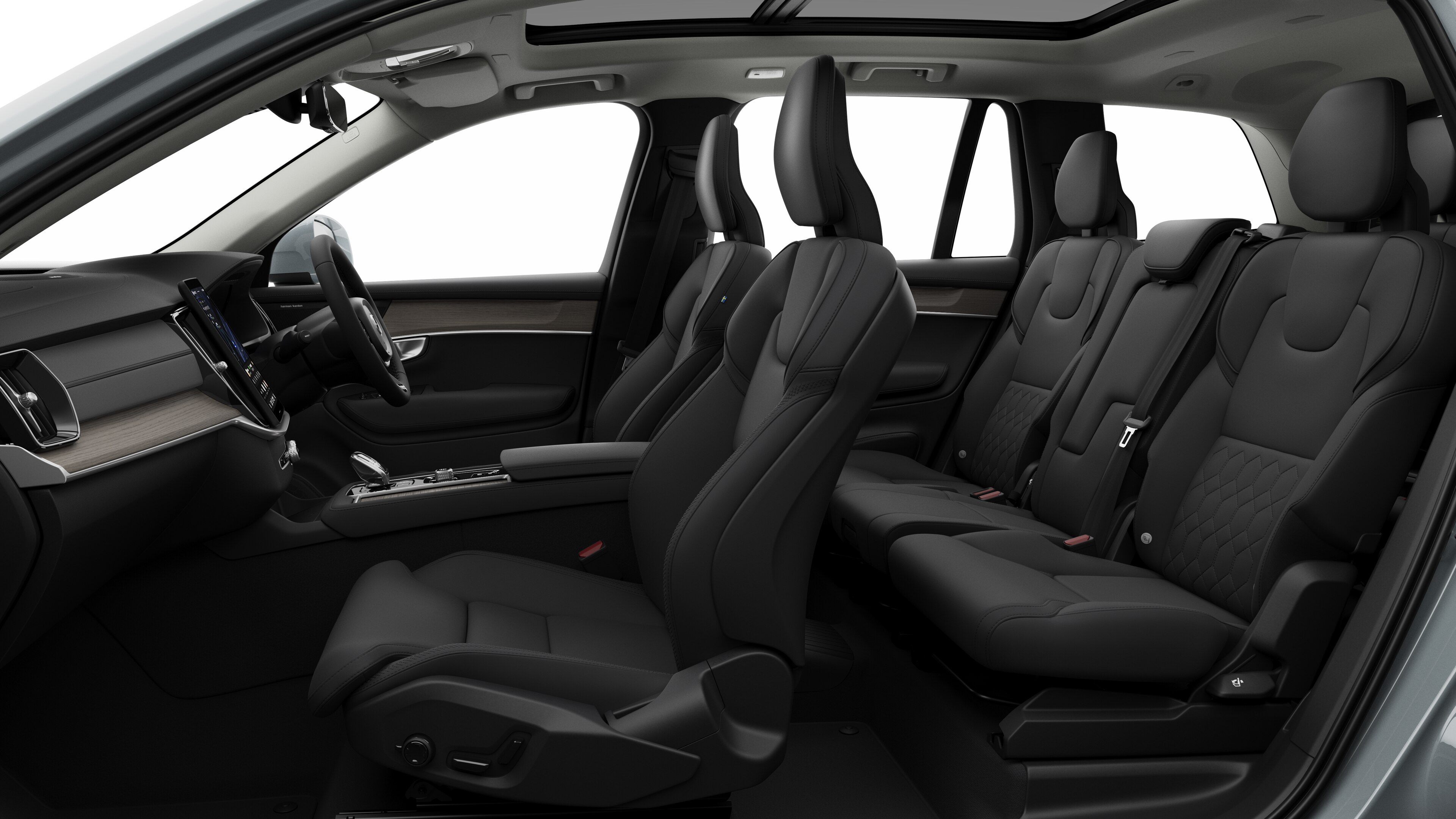 Volvo car interior side view showcasing front seats, rear passenger seats, steering wheel, dashboard, and center console, set against plain studio background.