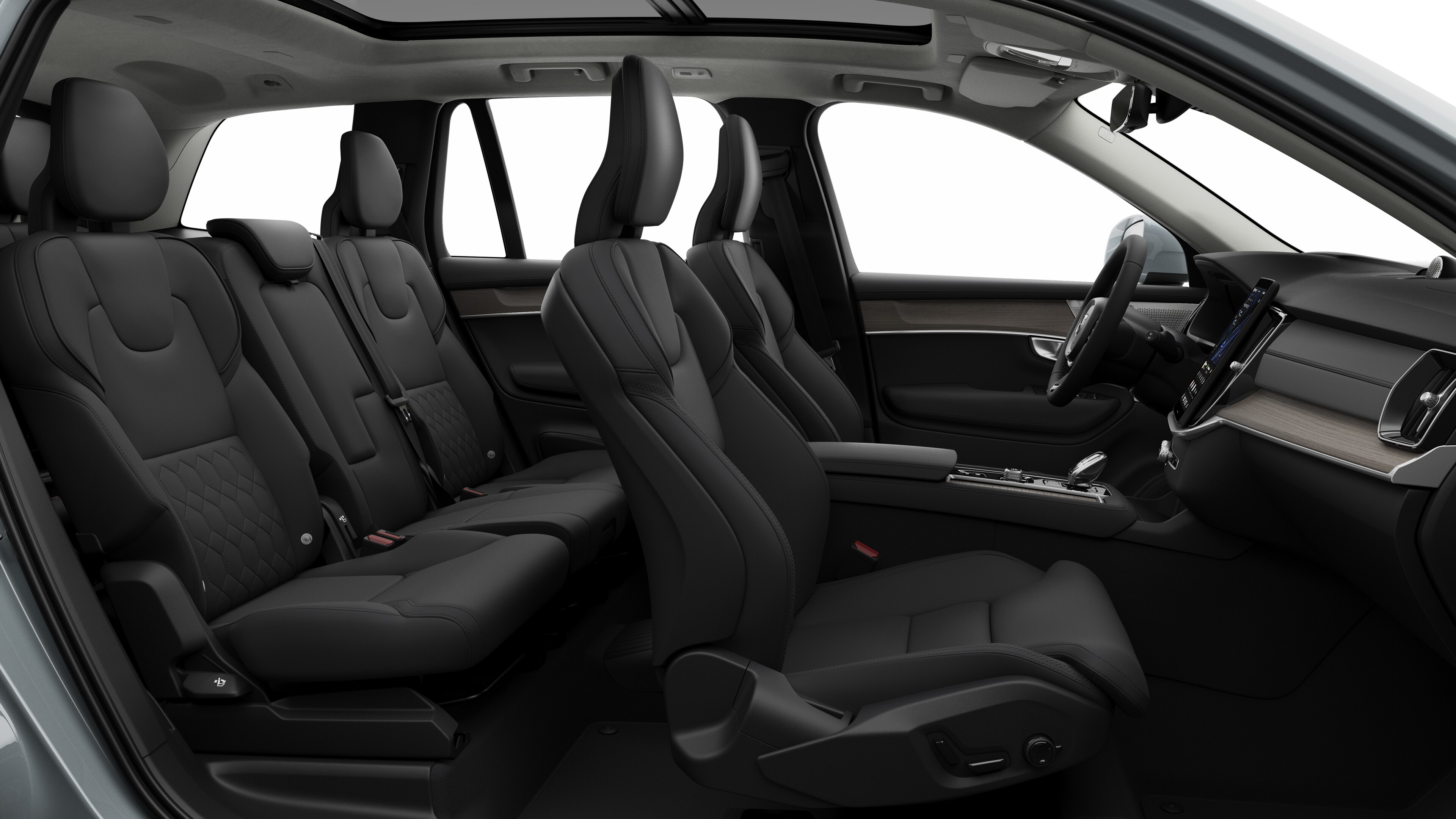 Volvo car interior side view showcasing front seats, rear passenger seats, steering wheel, dashboard, and center console, set against plain studio background.