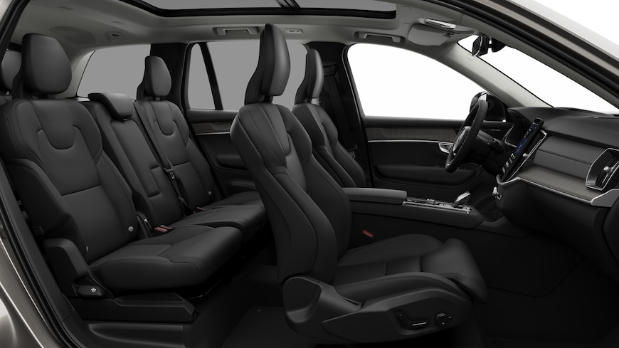 Volvo car interior side view showcasing front seats, rear passenger seats, steering wheel, dashboard, and center console, set against plain studio background.