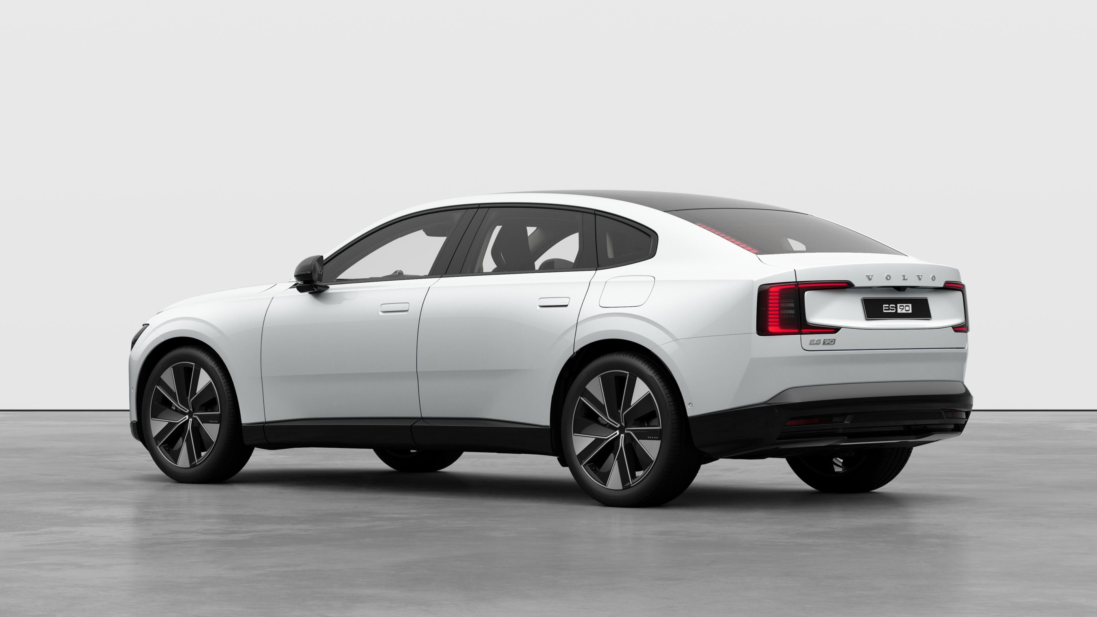 Volvo car rear three-quarter view in a plain studio background.