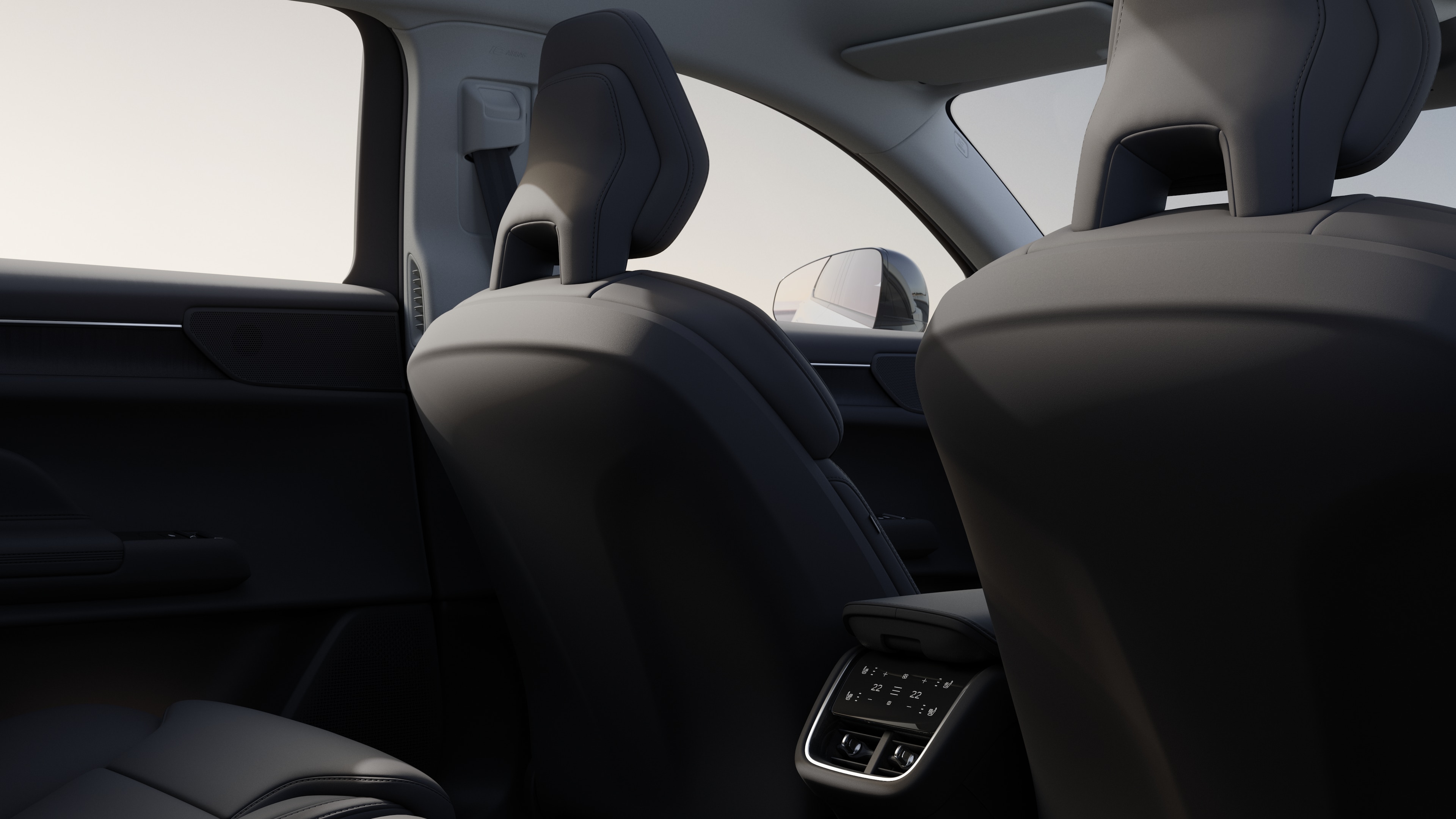 Volvo car interior rear passenger seat view showing rear seats and part of the side panel, with plain studio background visible through windows.