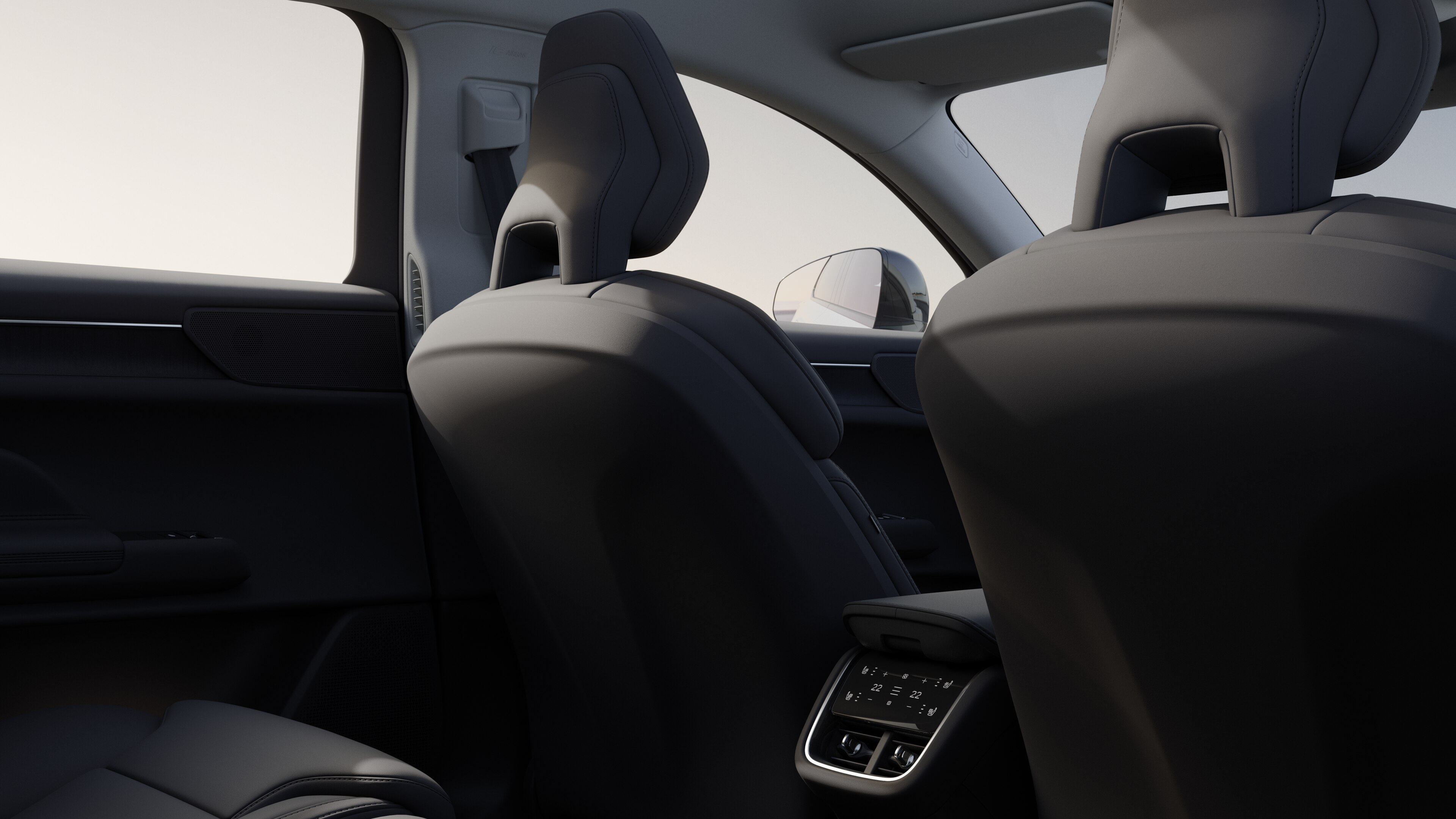 Volvo car interior rear passenger seat view showing rear seats and part of the side panel, with plain studio background visible through windows.