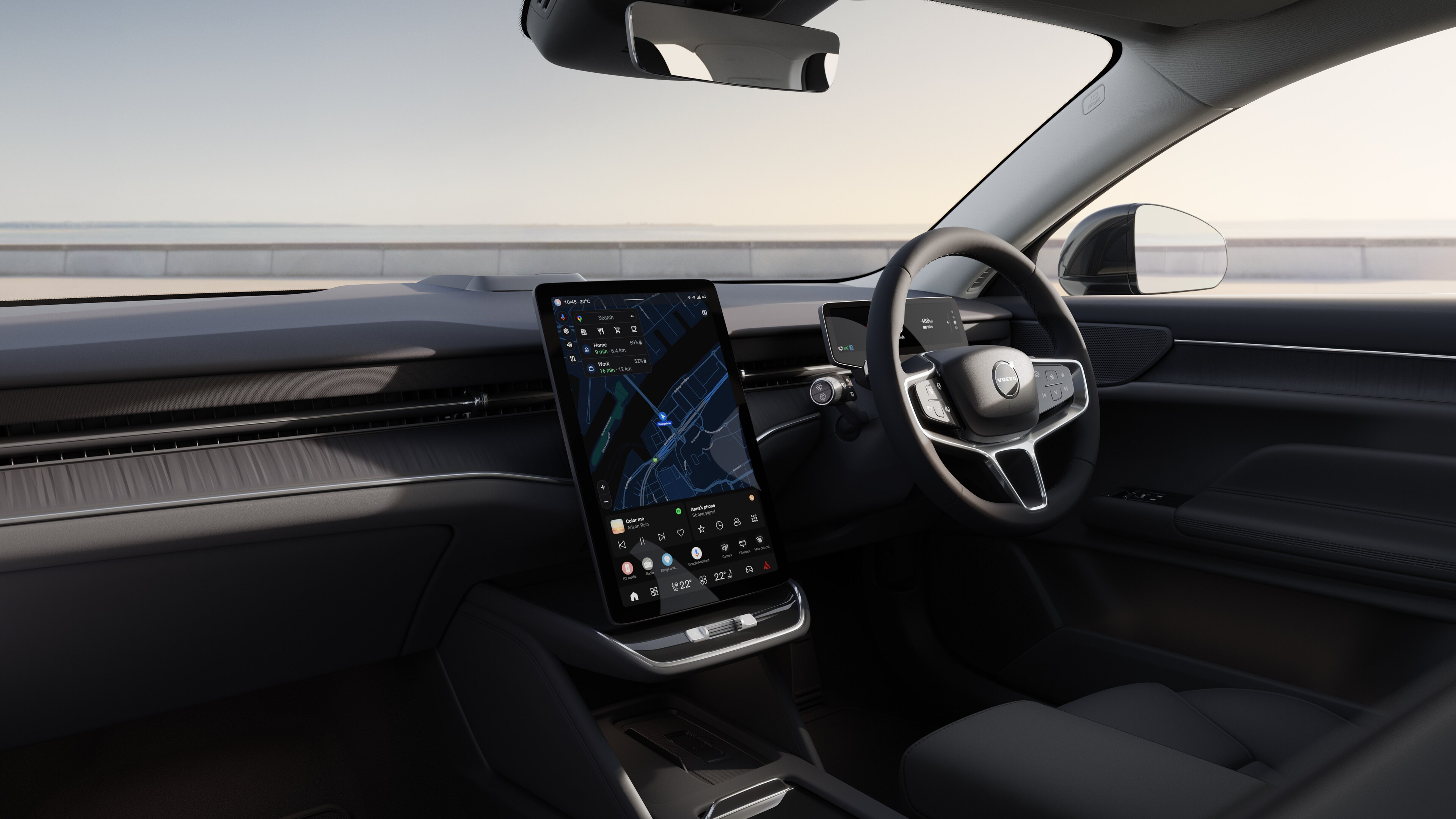 Volvo car interior showing dashboard, steering wheel, and center console with digital display in an open road background.