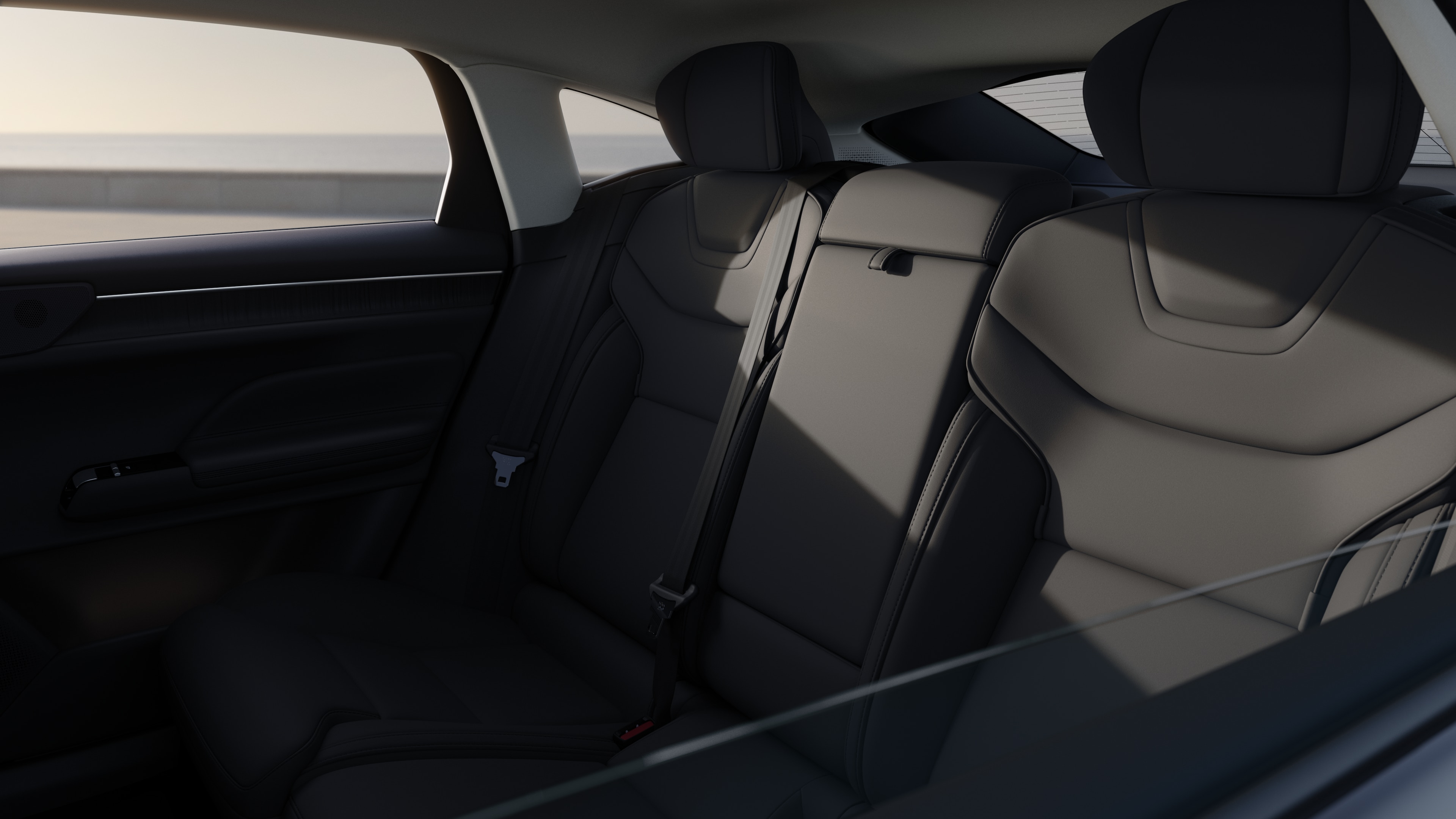 Volvo car interior showing front and rear passenger seats, steering wheel, dashboard, and center console against a plain studio background.