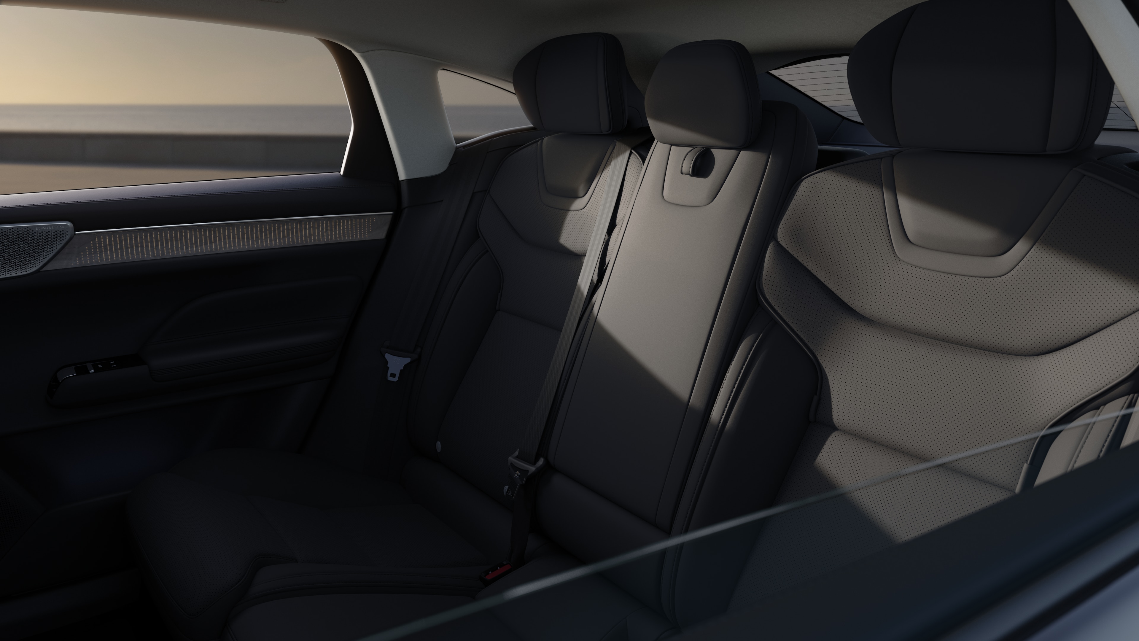 Volvo car interior showing front and rear passenger seats, steering wheel, dashboard, and center console against a plain studio background.