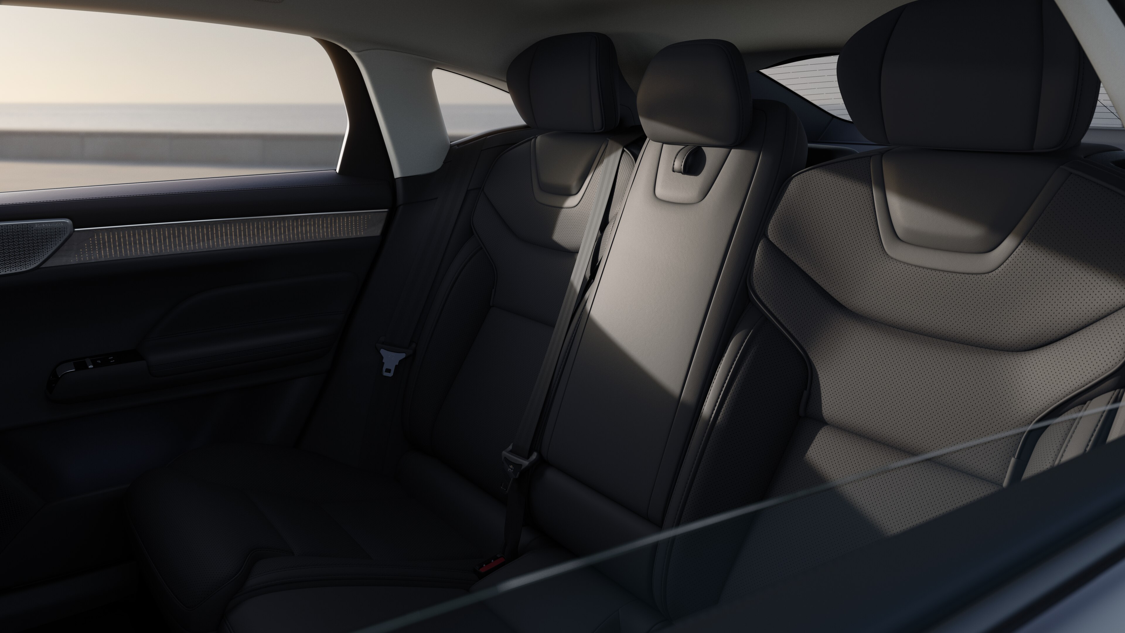 Volvo car interior showing front and rear passenger seats, steering wheel, dashboard, and center console against a plain studio background.