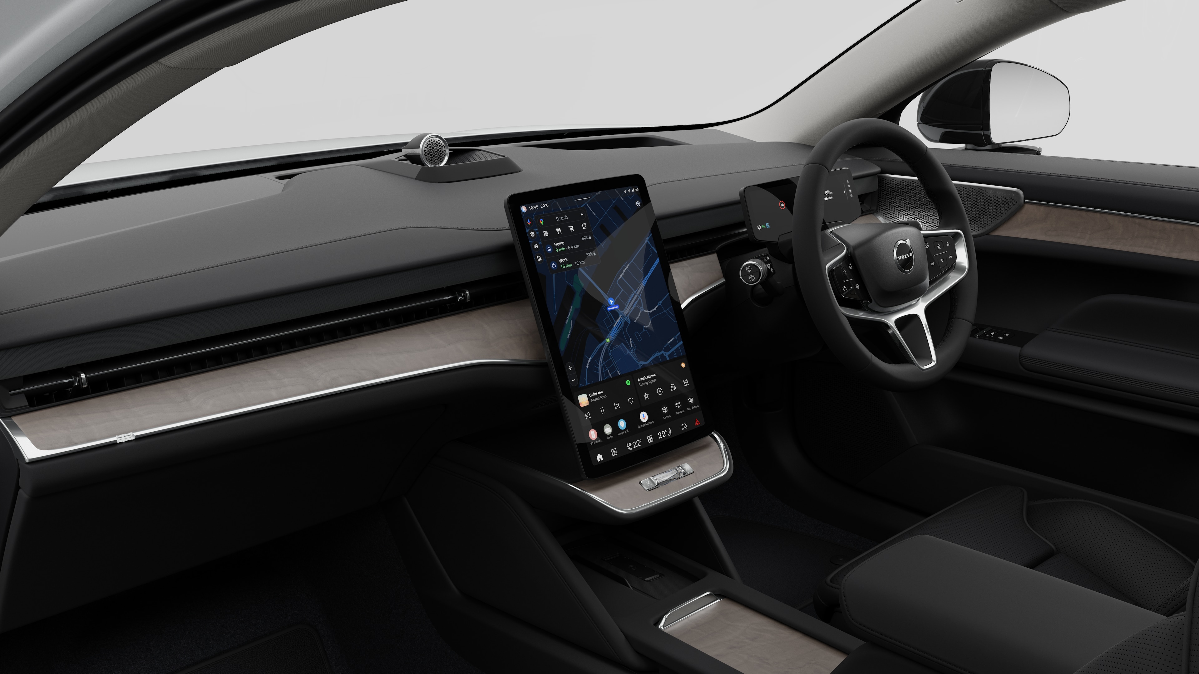 Interior view of a Volvo car showing the dashboard, steering wheel, center console, and digital display screen in a plain studio background.