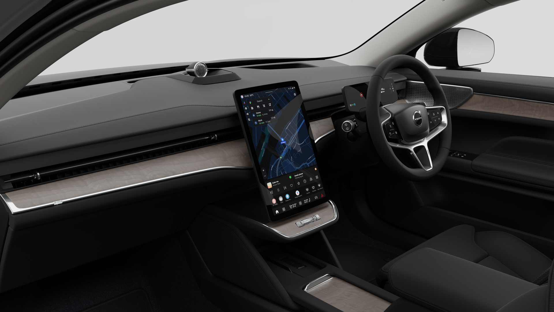 Interior view of a Volvo car showing the dashboard, steering wheel, center console, and digital display screen in a plain studio background.