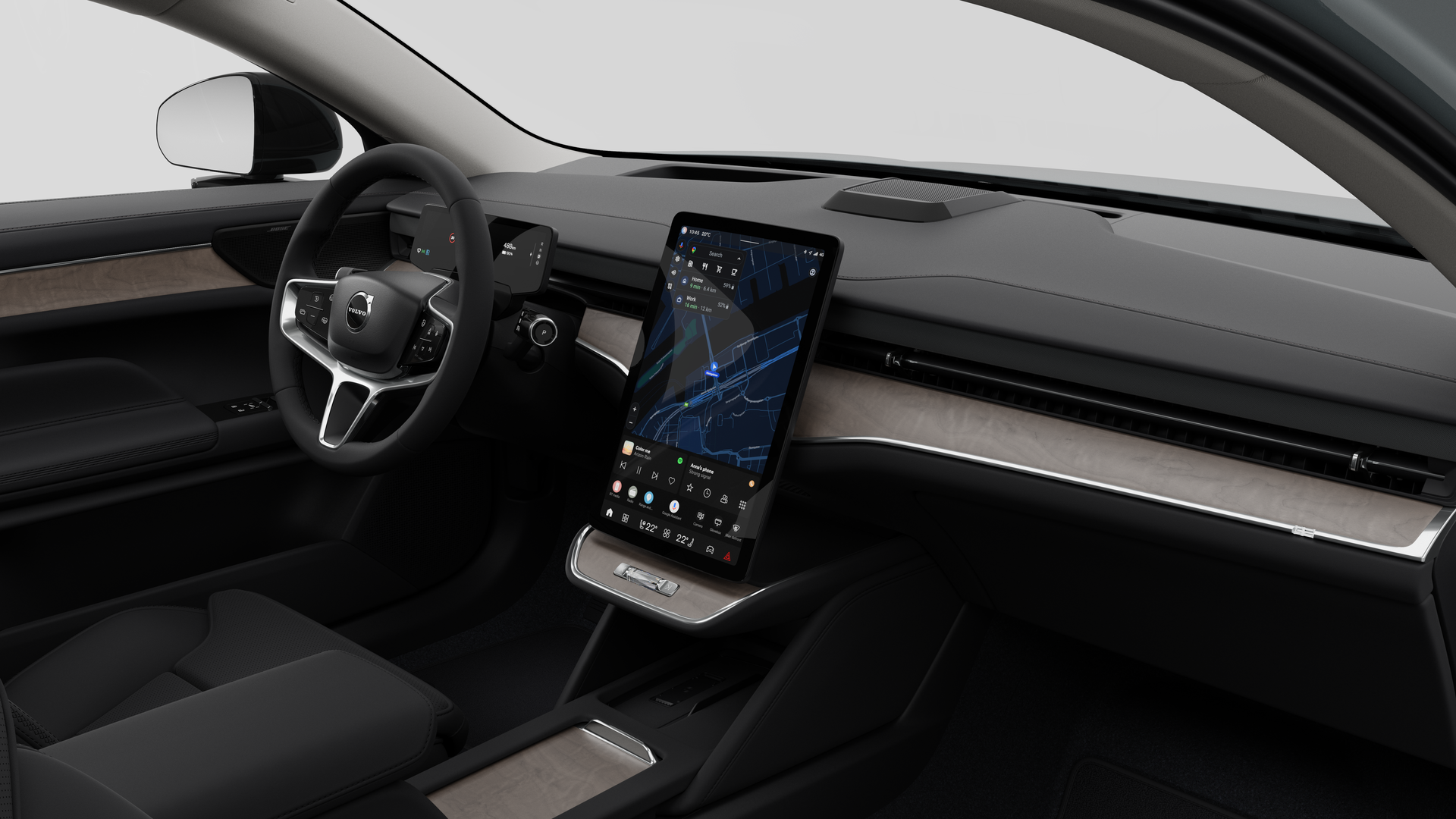 Interior view of a Volvo car showing the dashboard, steering wheel, center console, and digital display screen in a plain studio background.