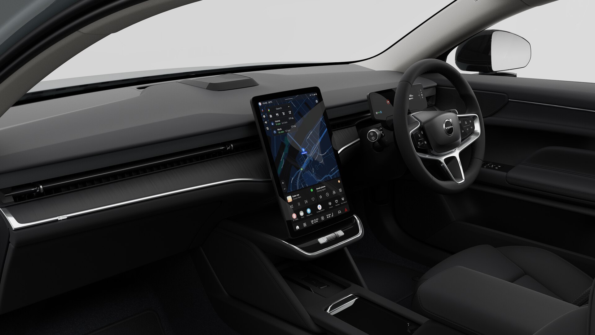 Interior view of a Volvo car showing the dashboard, steering wheel, center console, and digital display screen in a plain studio background.