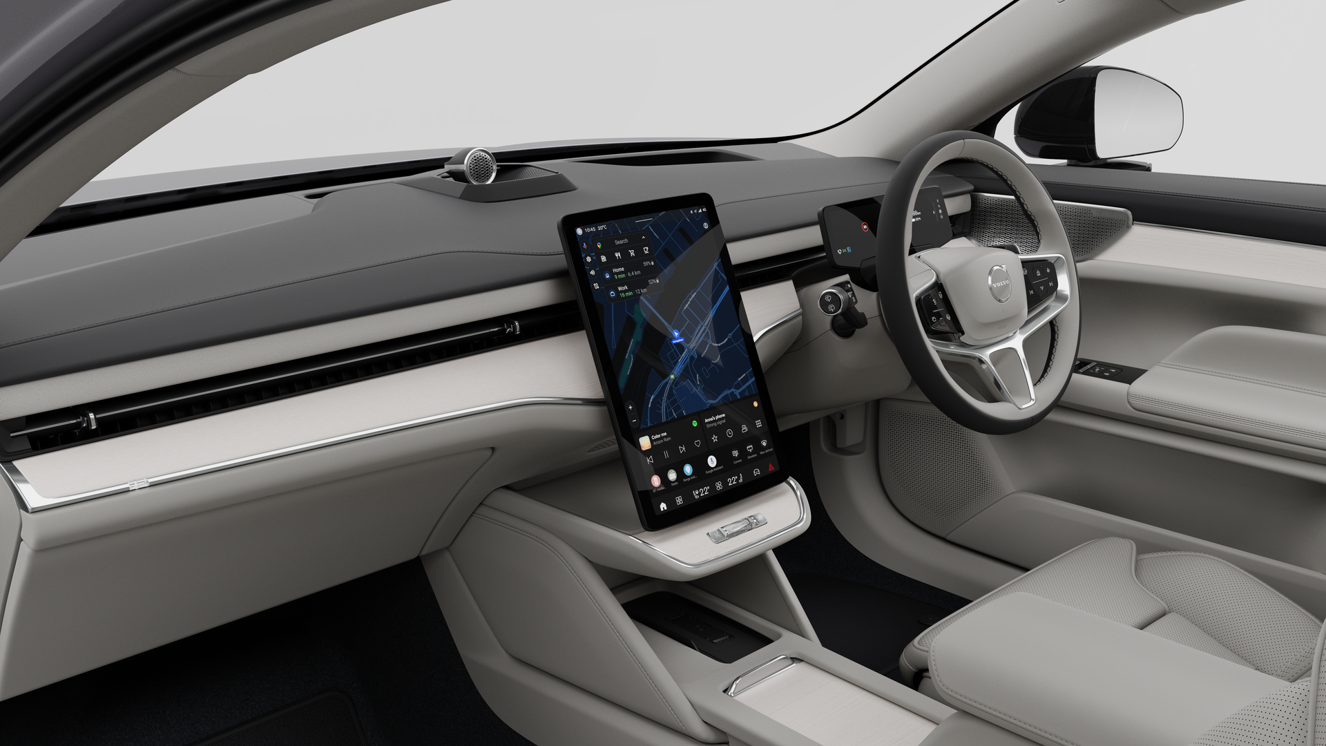 Interior view of a Volvo car showing the dashboard, steering wheel, center console, and digital display screen in a plain studio background.