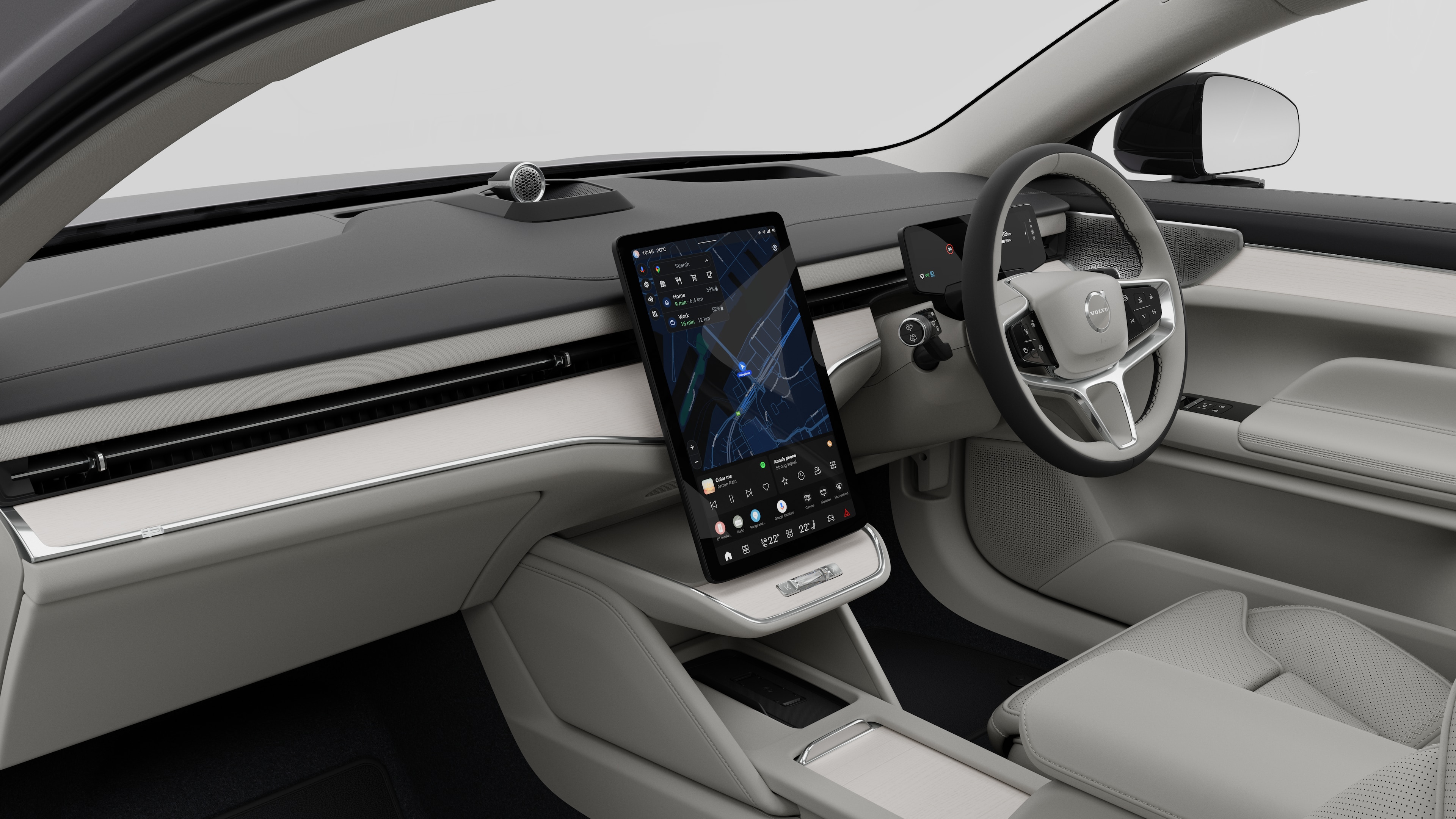 Interior view of a Volvo car showing the dashboard, steering wheel, center console, and digital display screen in a plain studio background.