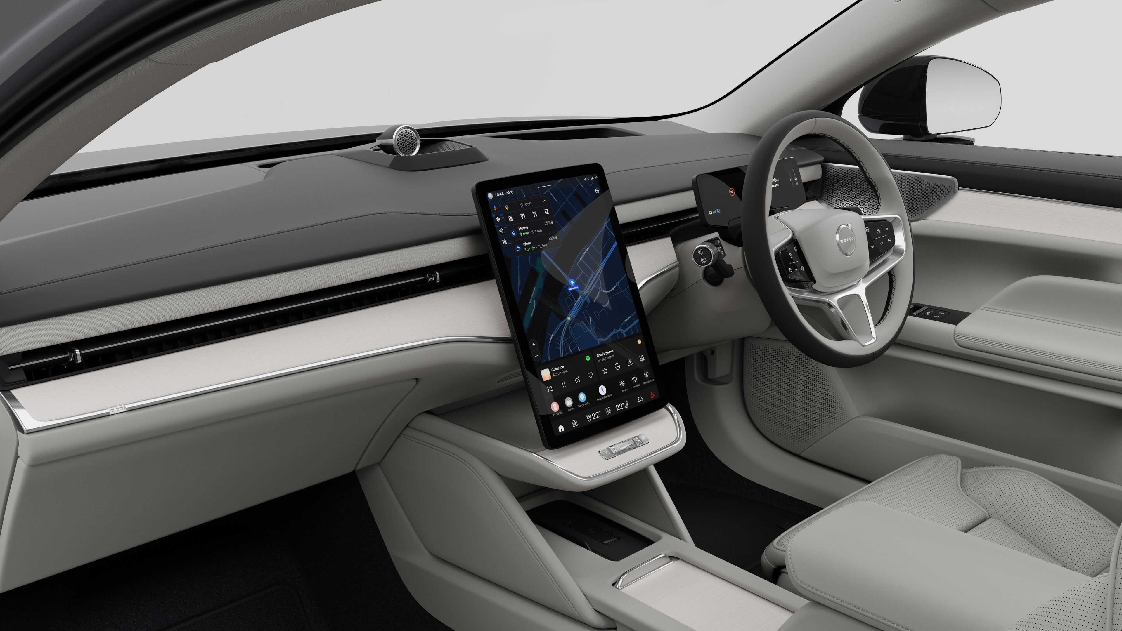 Interior view of a Volvo car showing the dashboard, steering wheel, center console, and digital display screen in a plain studio background.