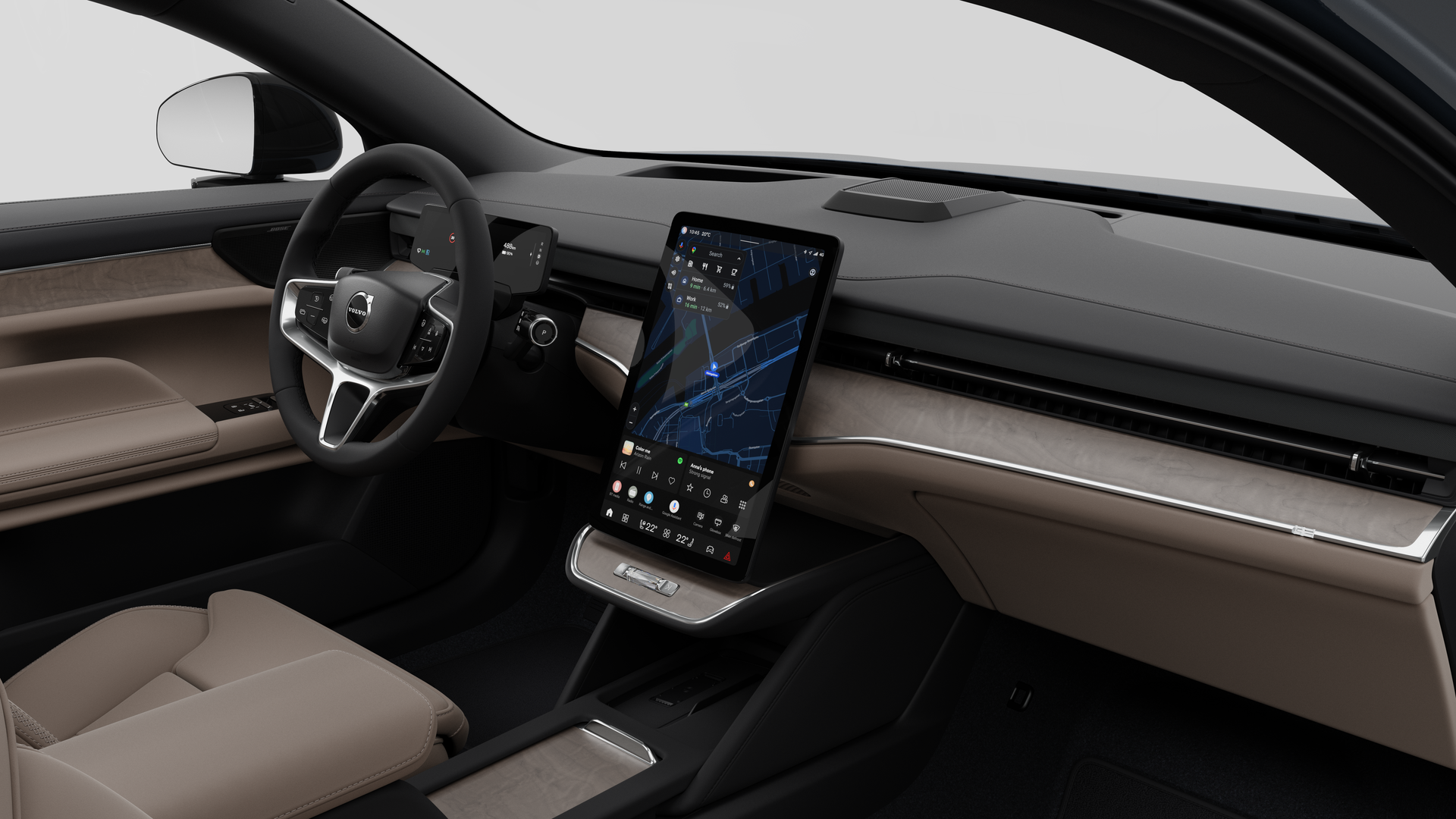 Vue intérieure d’une Volvo montrant le tableau de bord, le volant, la console centrale et l’écran d’affichage numérique sur un fond de studio uni.