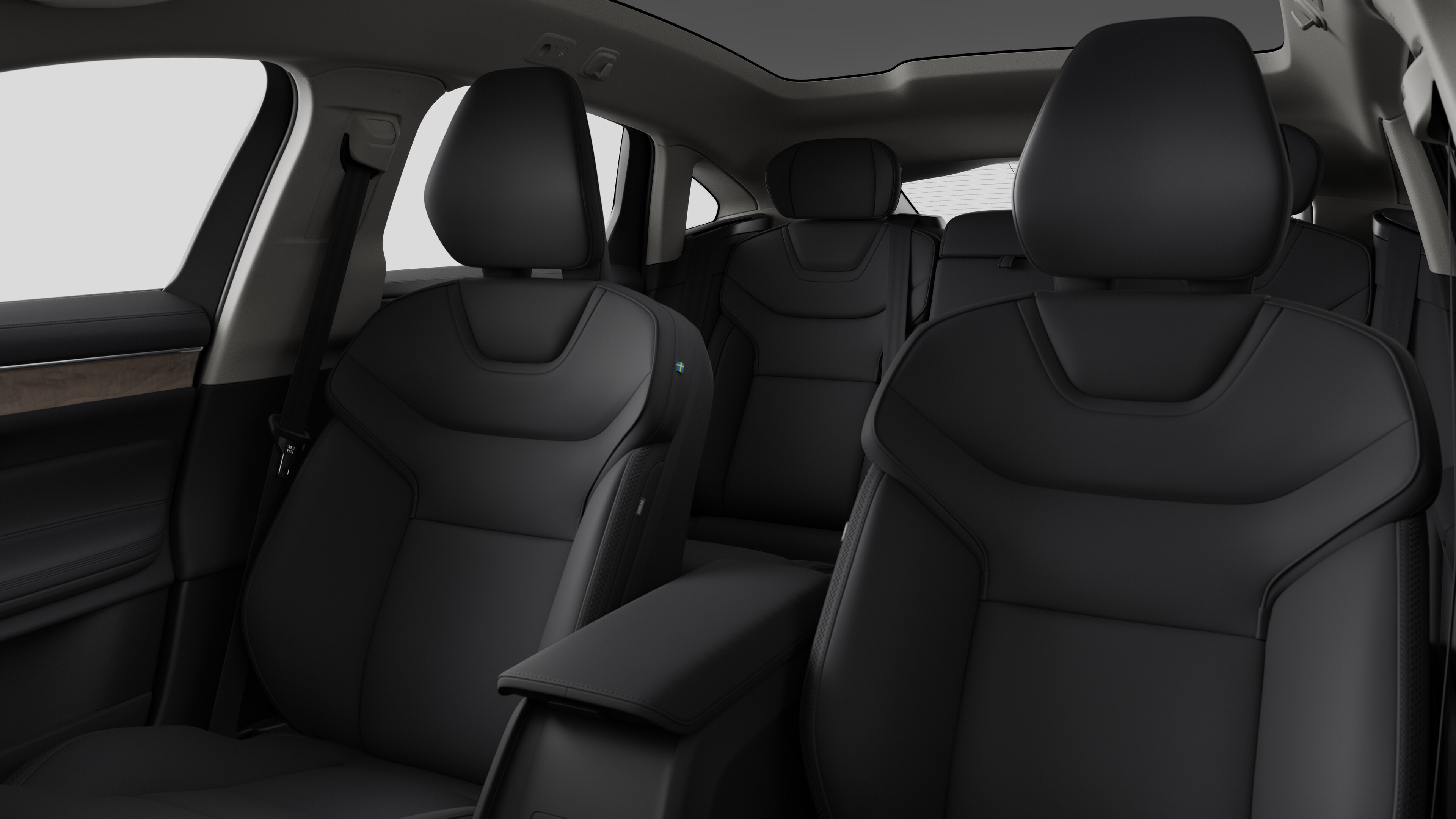 Volvo -auton sisätilat, takamatkustajan istuimet ja keskikonsoli selkeällä studiotaustalla.