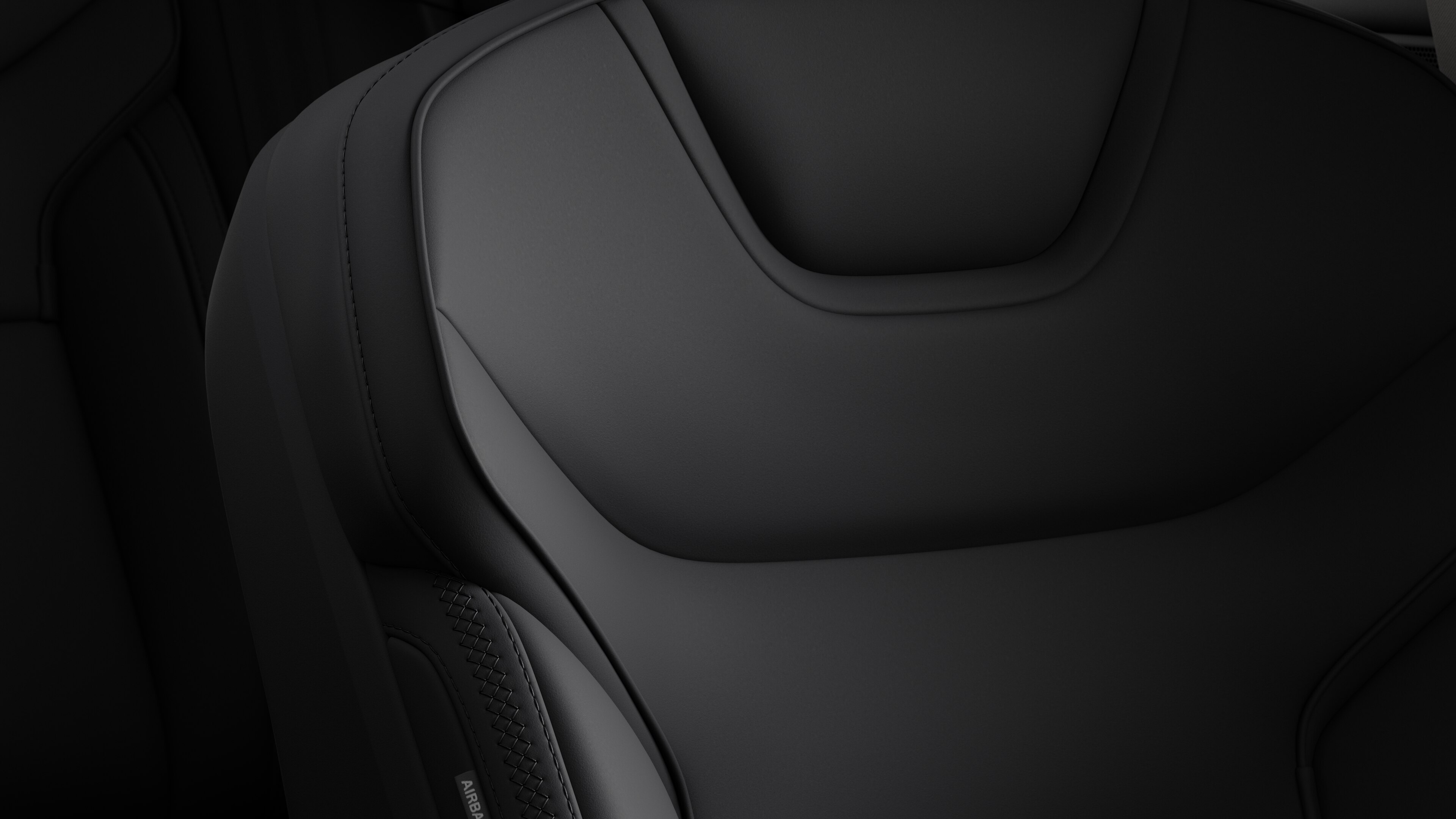 Close-up of Volvo car interior seat detail showing stitching and a small Swedish flag tag.