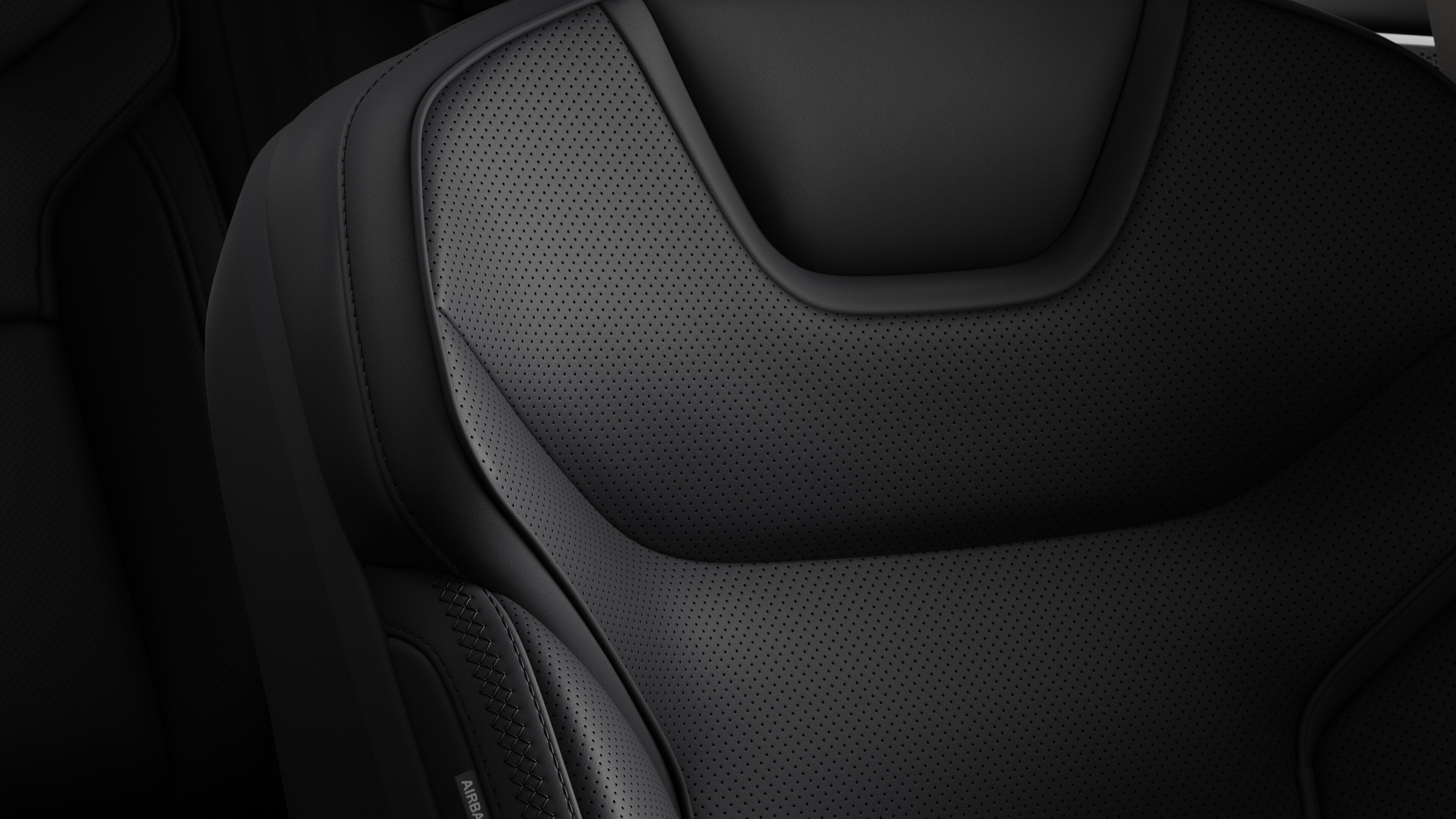 Close-up of Volvo car interior seat detail showing stitching and a small Swedish flag tag.