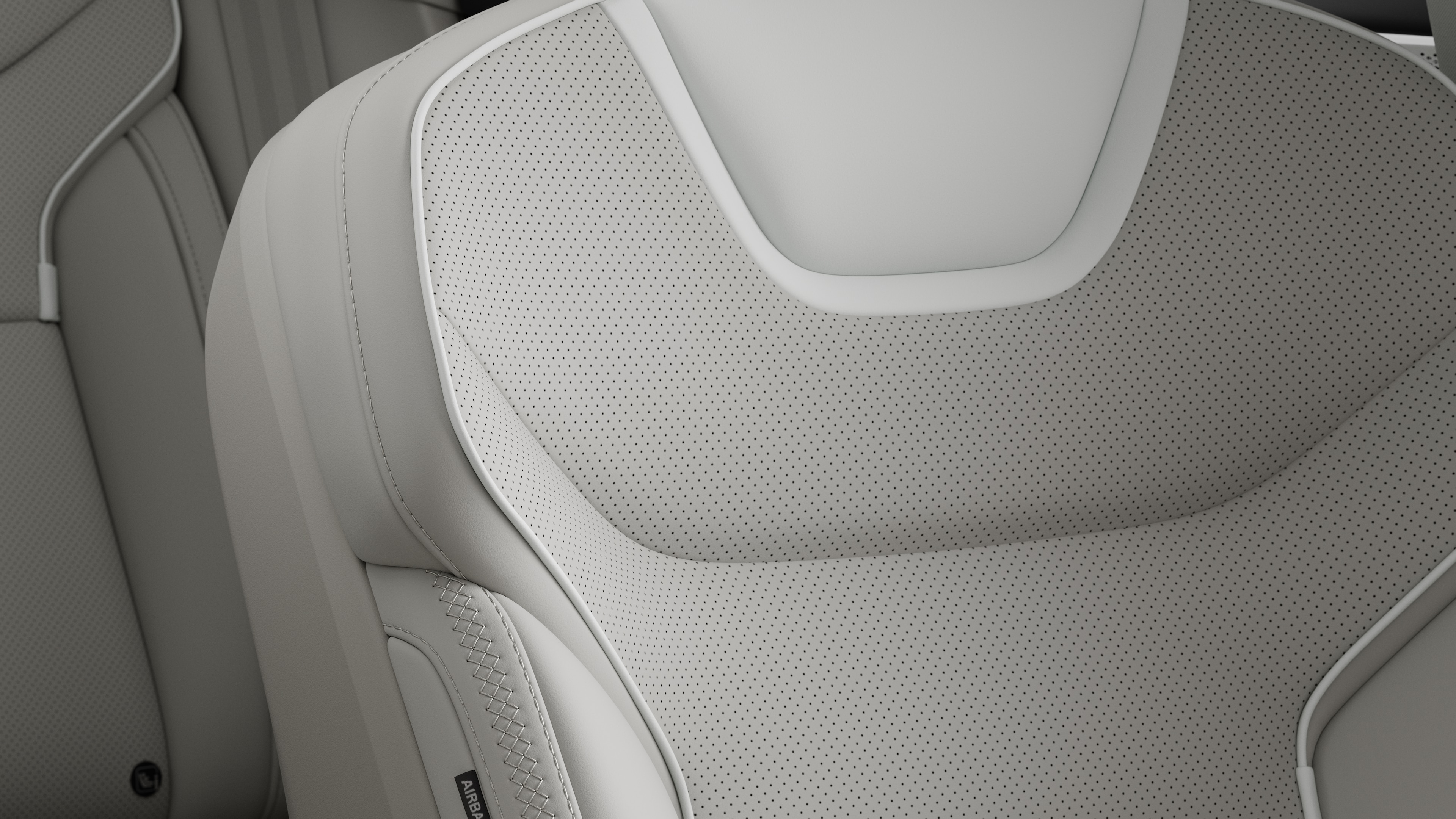 Close-up of Volvo car interior seat detail showing stitching and a small Swedish flag tag.