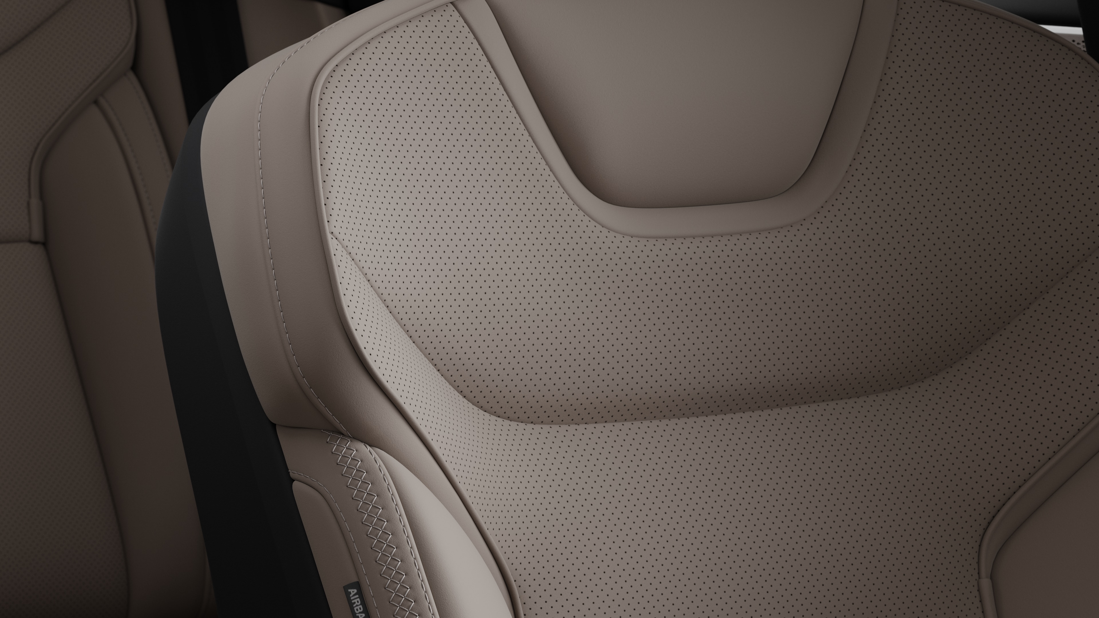 Close-up of Volvo car interior seat detail showing stitching and a small Swedish flag tag.