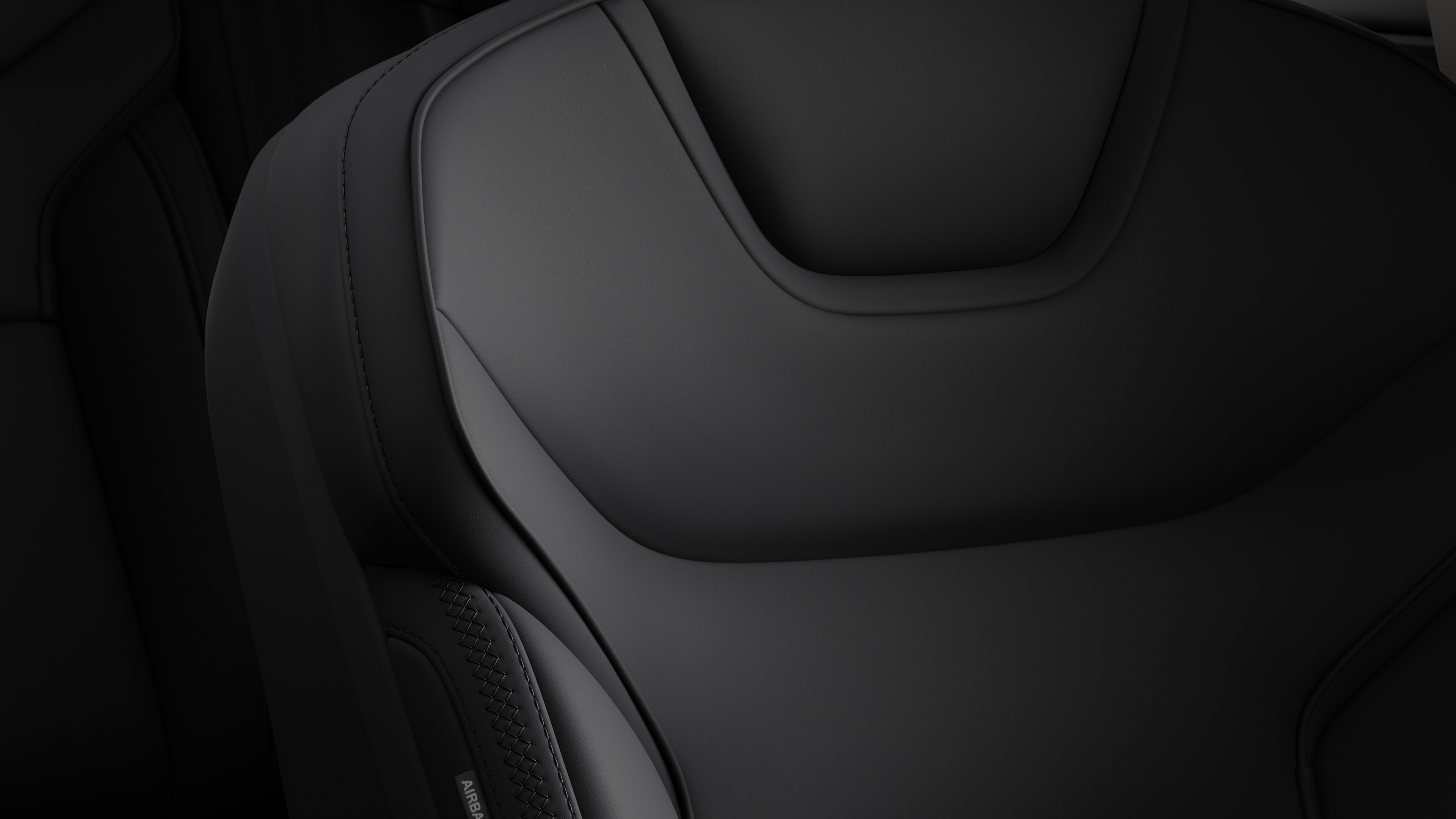 Close-up of Volvo car interior seat detail showing stitching and a small Swedish flag tag.