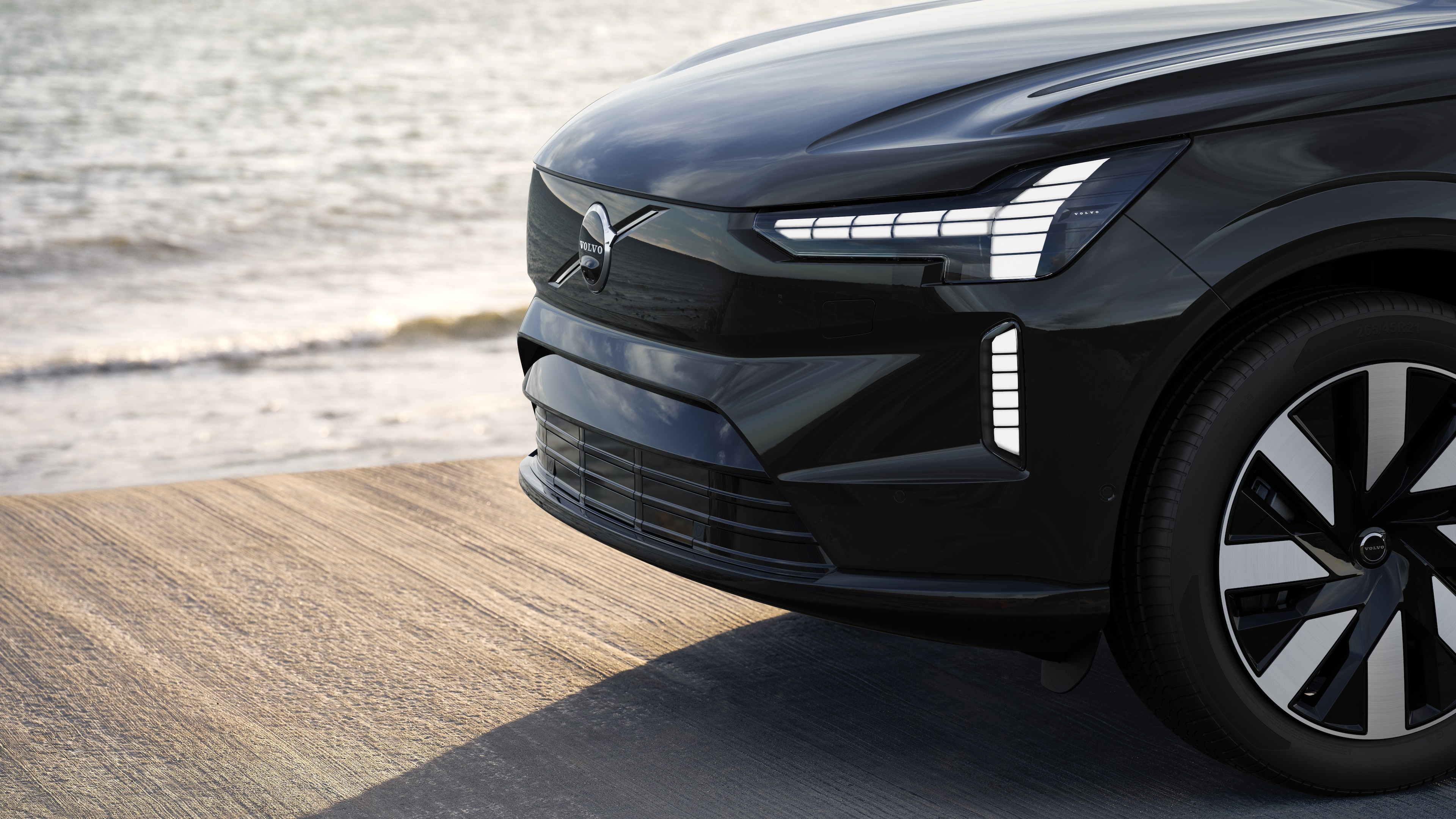 Esterno di un'auto Volvo vista di tre quarti sullo sfondo di un muro di cemento industriale.