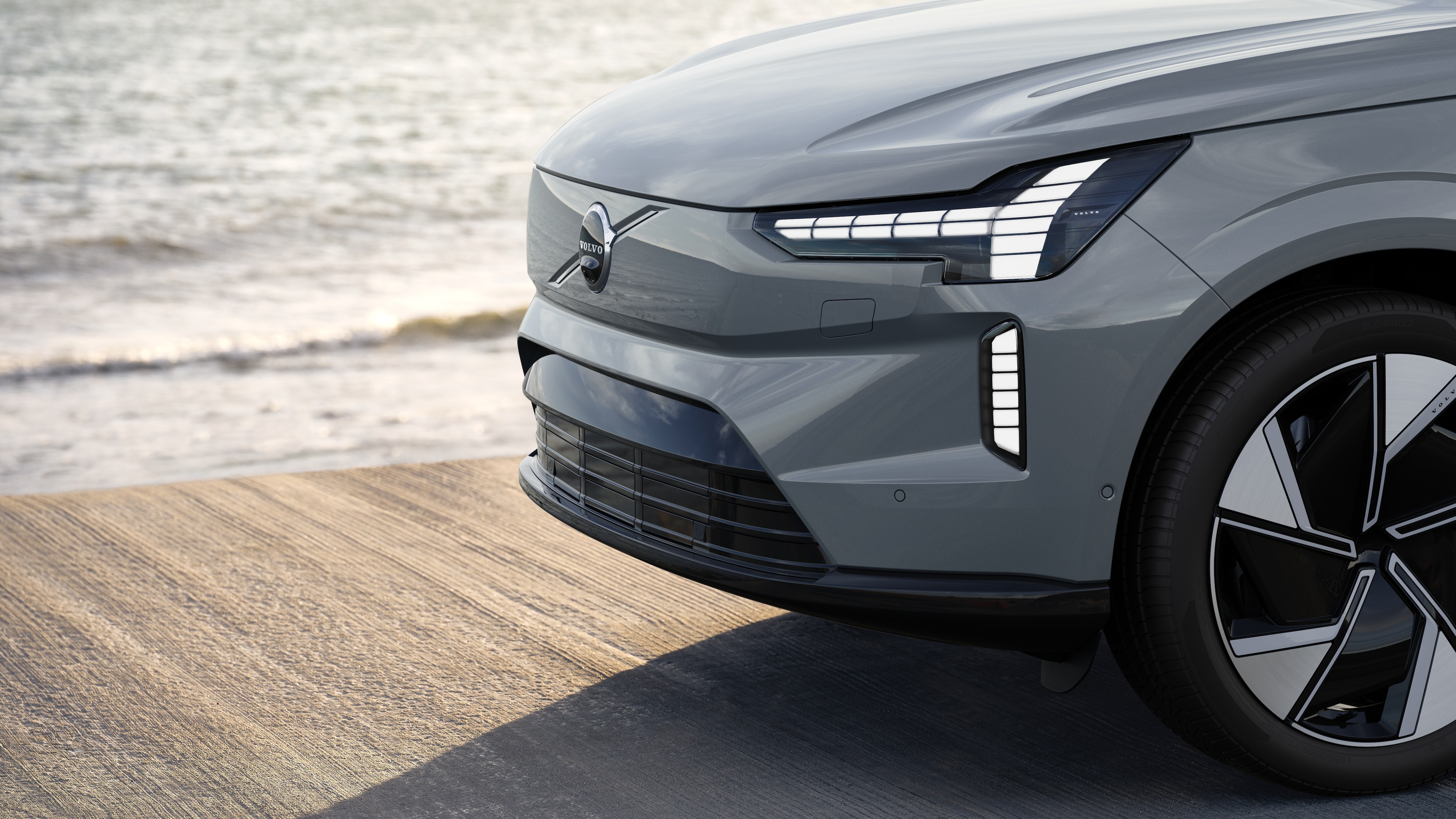 Volvo car exterior in three-quarter view against an industrial concrete wall background.