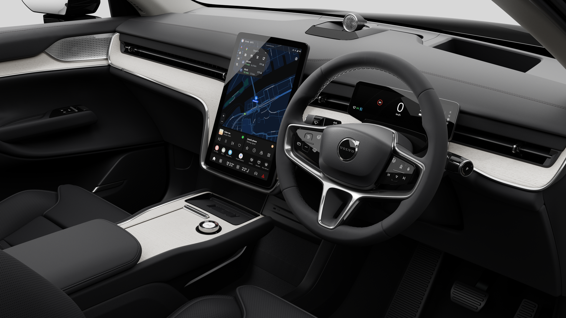 Interior view of a Volvo car showing the dashboard, steering wheel, center console, and digital display screen in a plain studio background.
