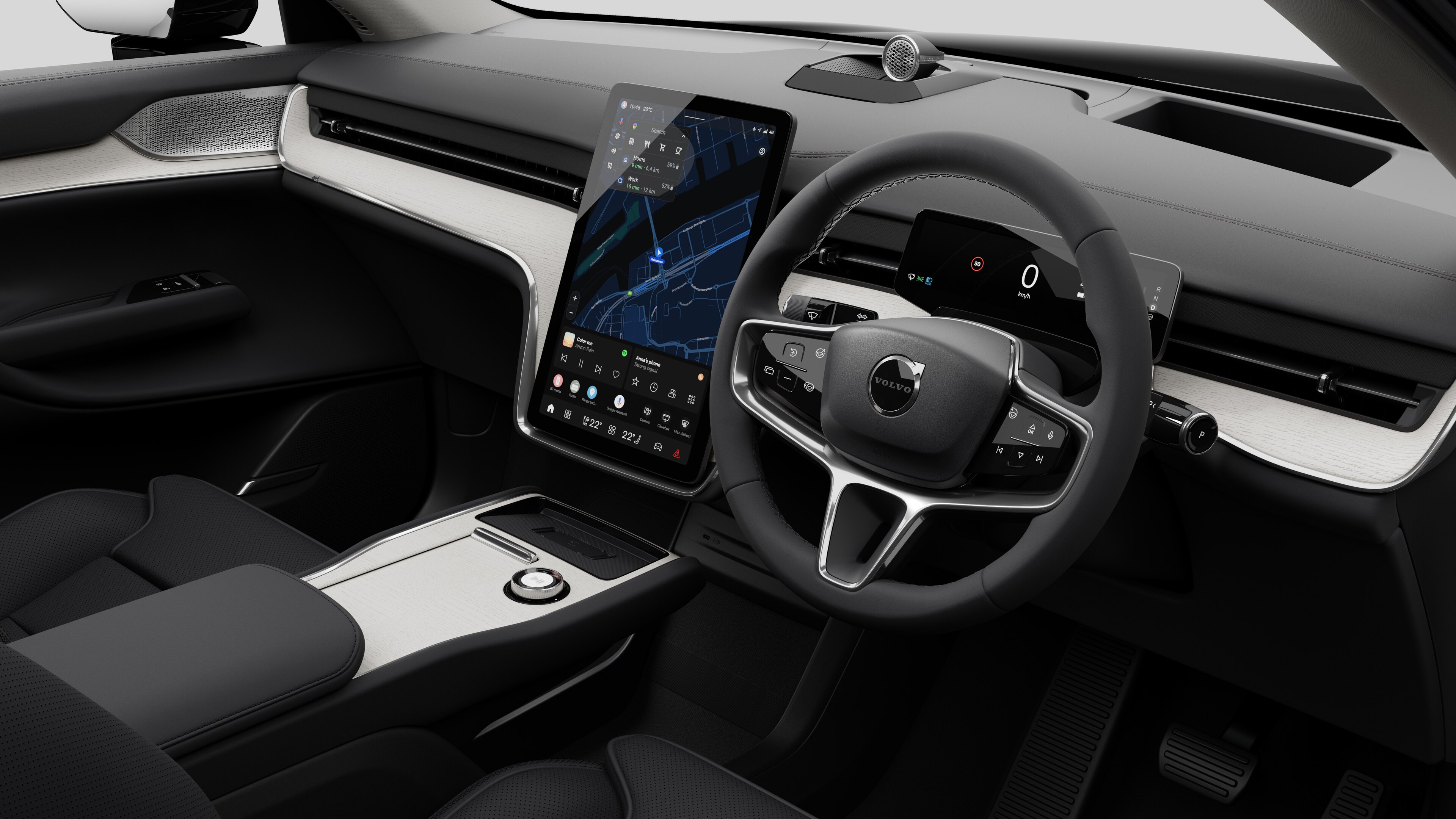 Interior view of a Volvo car showing the dashboard, steering wheel, center console, and digital display screen in a plain studio background.