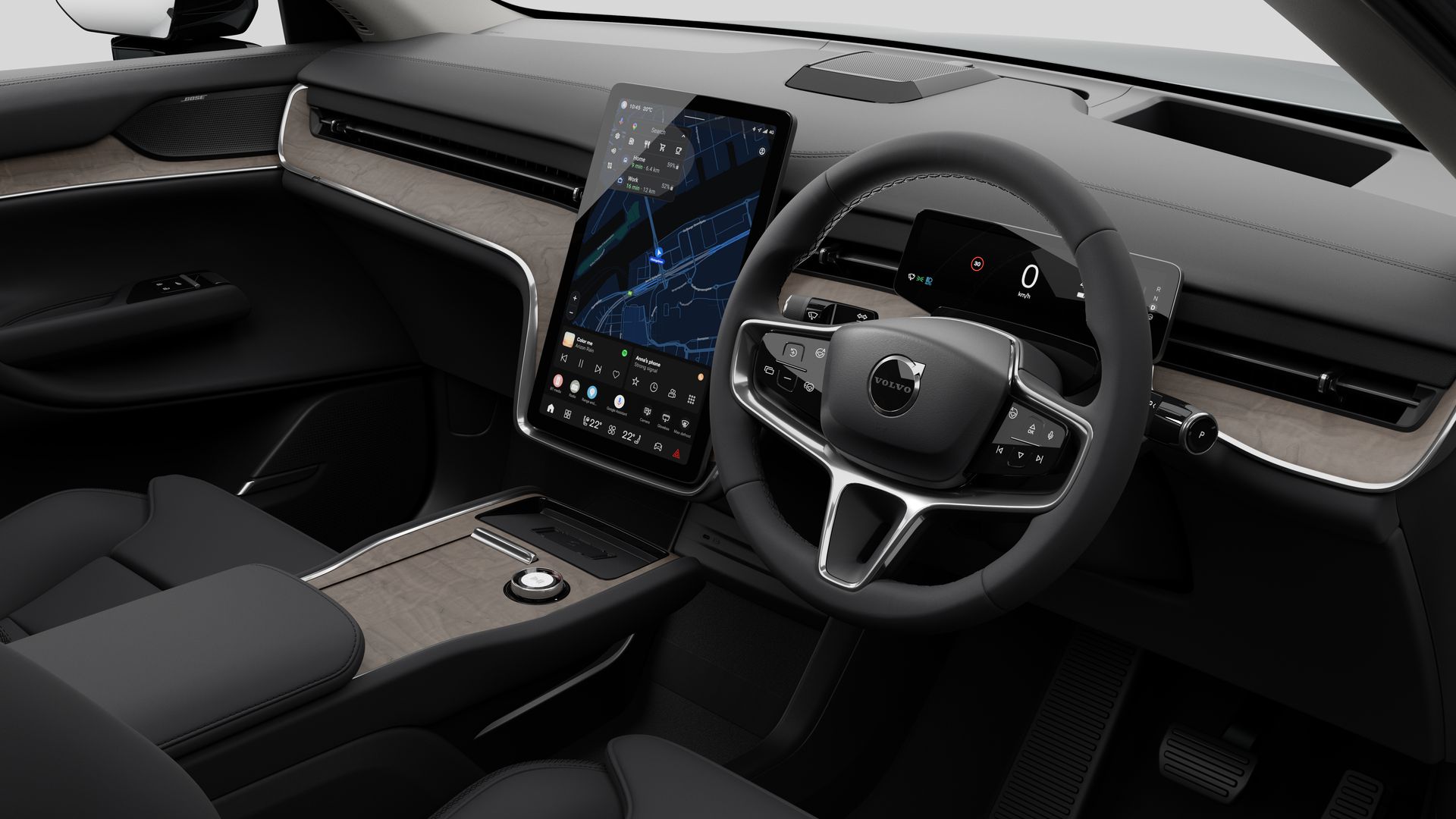 Interior view of a Volvo car showing the dashboard, steering wheel, center console, and digital display screen in a plain studio background.