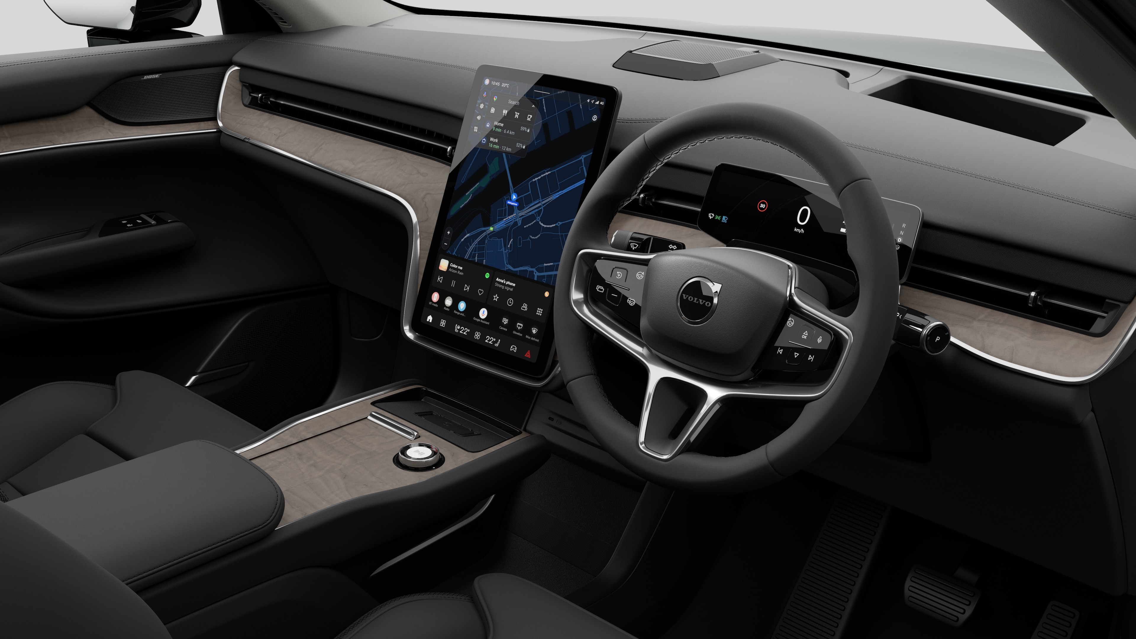 Interior view of a Volvo car showing the dashboard, steering wheel, center console, and digital display screen in a plain studio background.