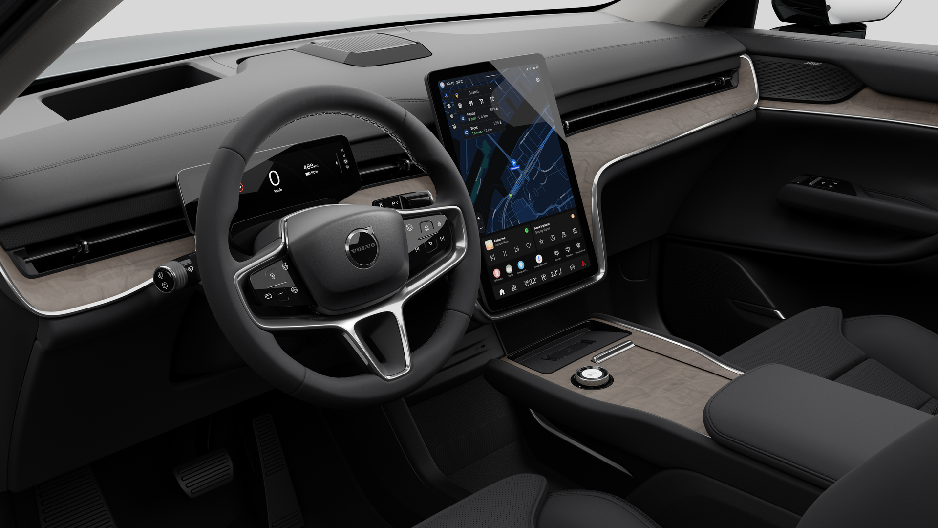 Interior view of a Volvo car showing the dashboard, steering wheel, center console, and digital display screen in a plain studio background.